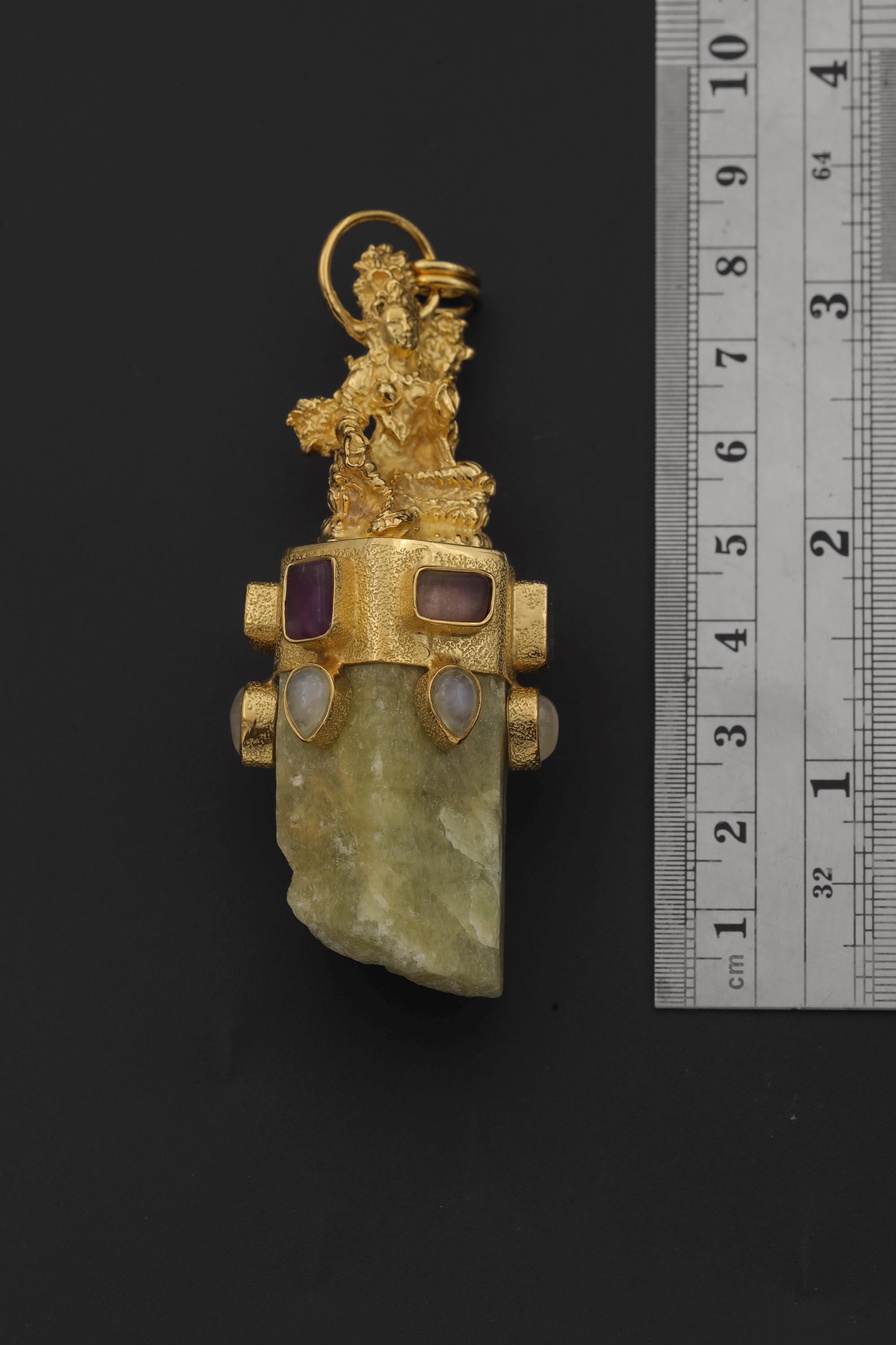 Praying Sarasvati Aquamarine Amethyst Moonstone pendant shown beside a ruler for scale, measuring approximately 8 cm long.