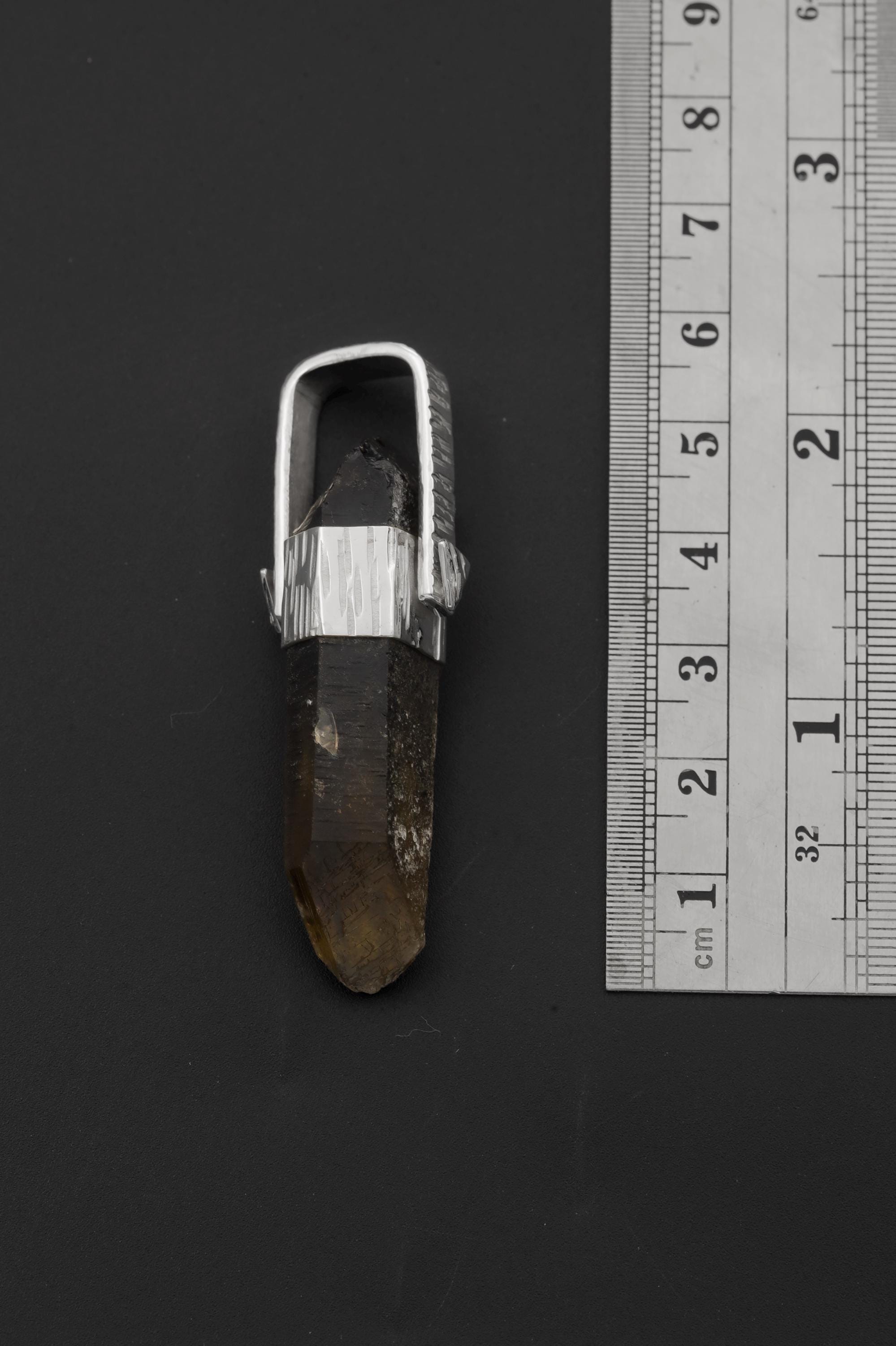 Australian Record Keeper Citrine Quartz pendant shown beside a ruler for scale, measuring approximately 6.5 cm long.