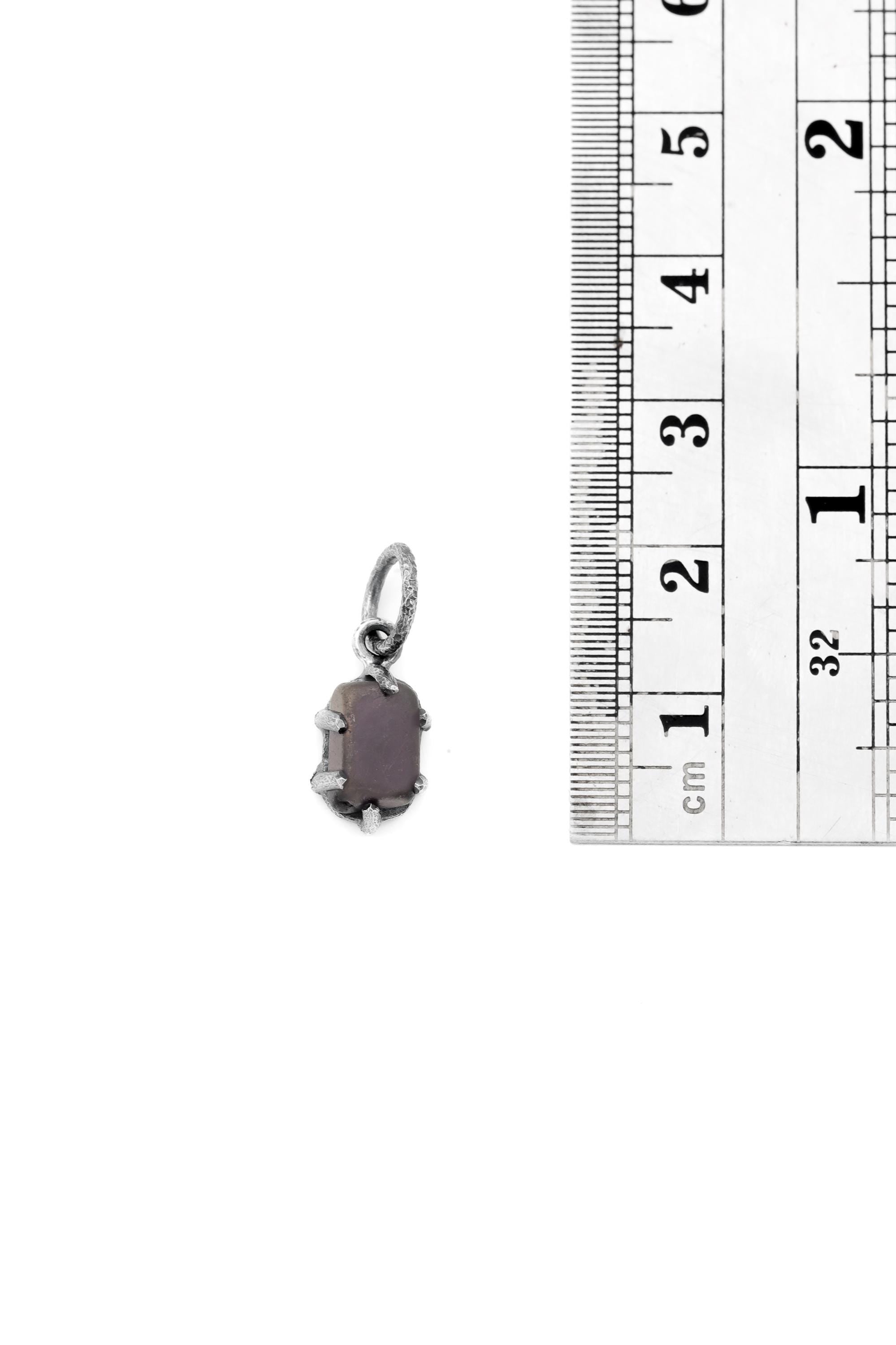 Facet Grade Amethyst Cube Pendant shown beside ruler 2cm for scale with oxidized sterling silver claw setting.