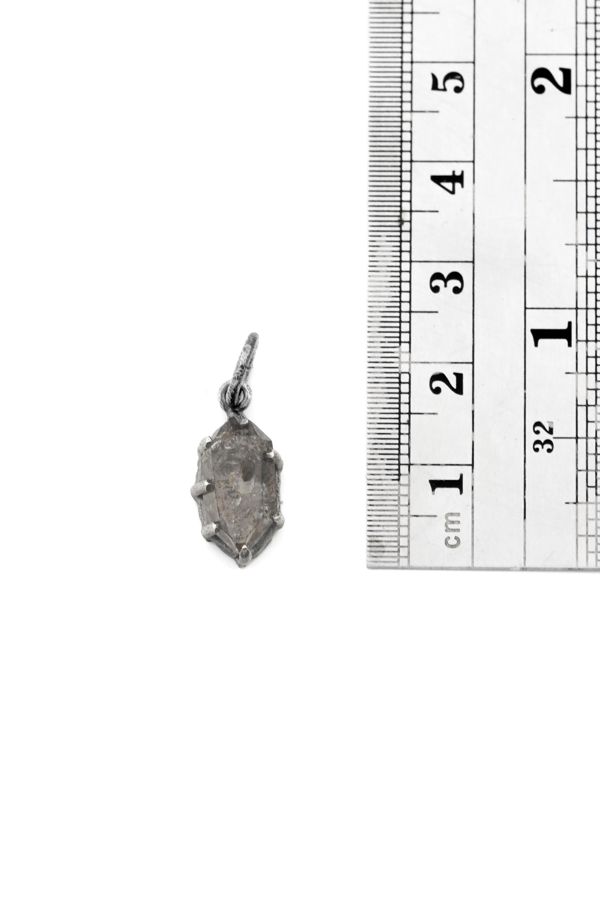 Tibetan Petroleum Inclusion Quartz pendant shown beside a ruler for scale, measuring approximately 2.5 to 3 cm long including bail.