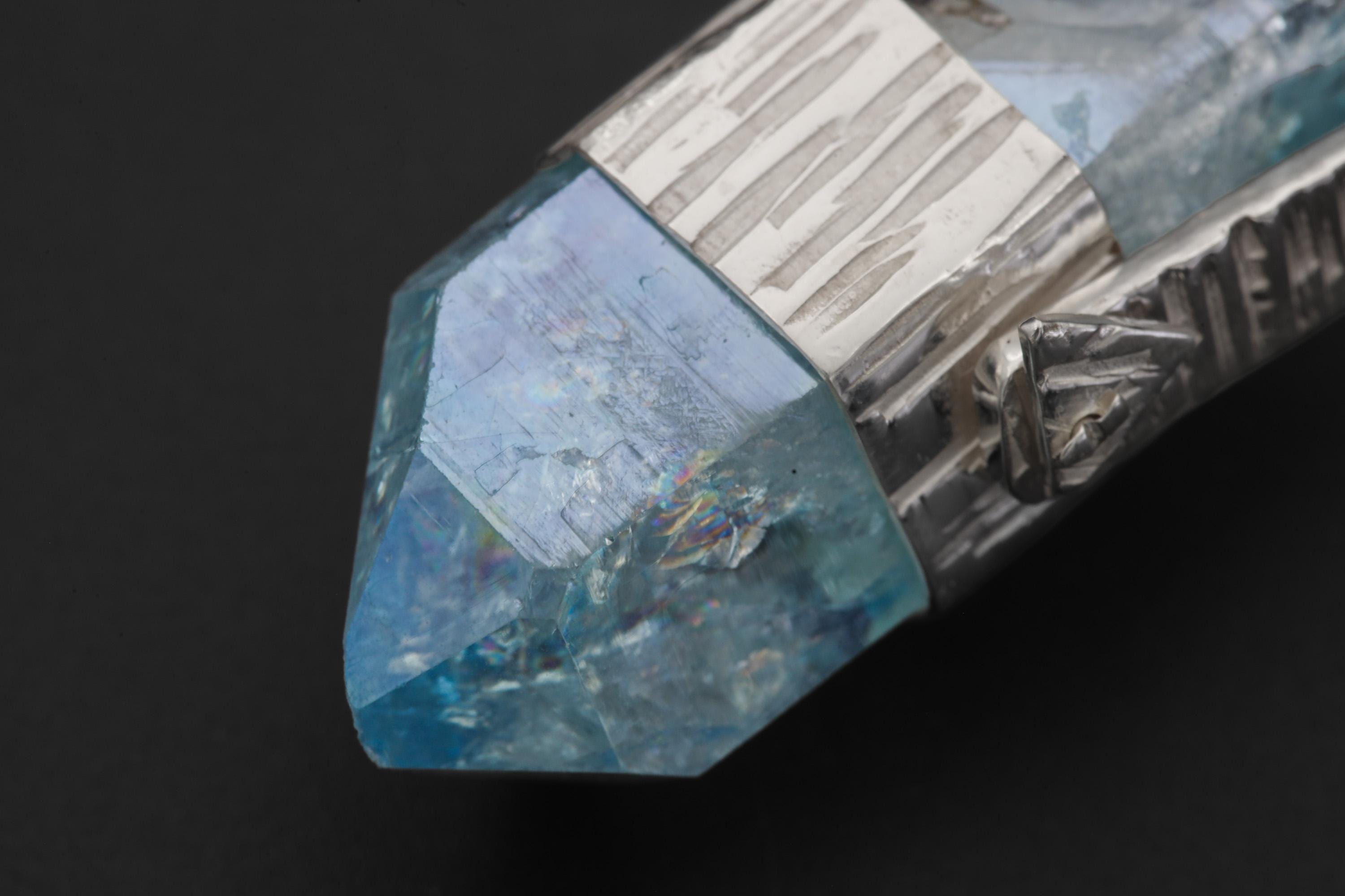 Close-up of Double Terminated Aqua Aura Quartz point showing internal inclusions, aqua colour, and natural crystal form.