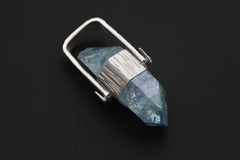 Double Terminated Aqua Aura Quartz pendant on black background with line-hammered sterling silver and wide hinged bail.
