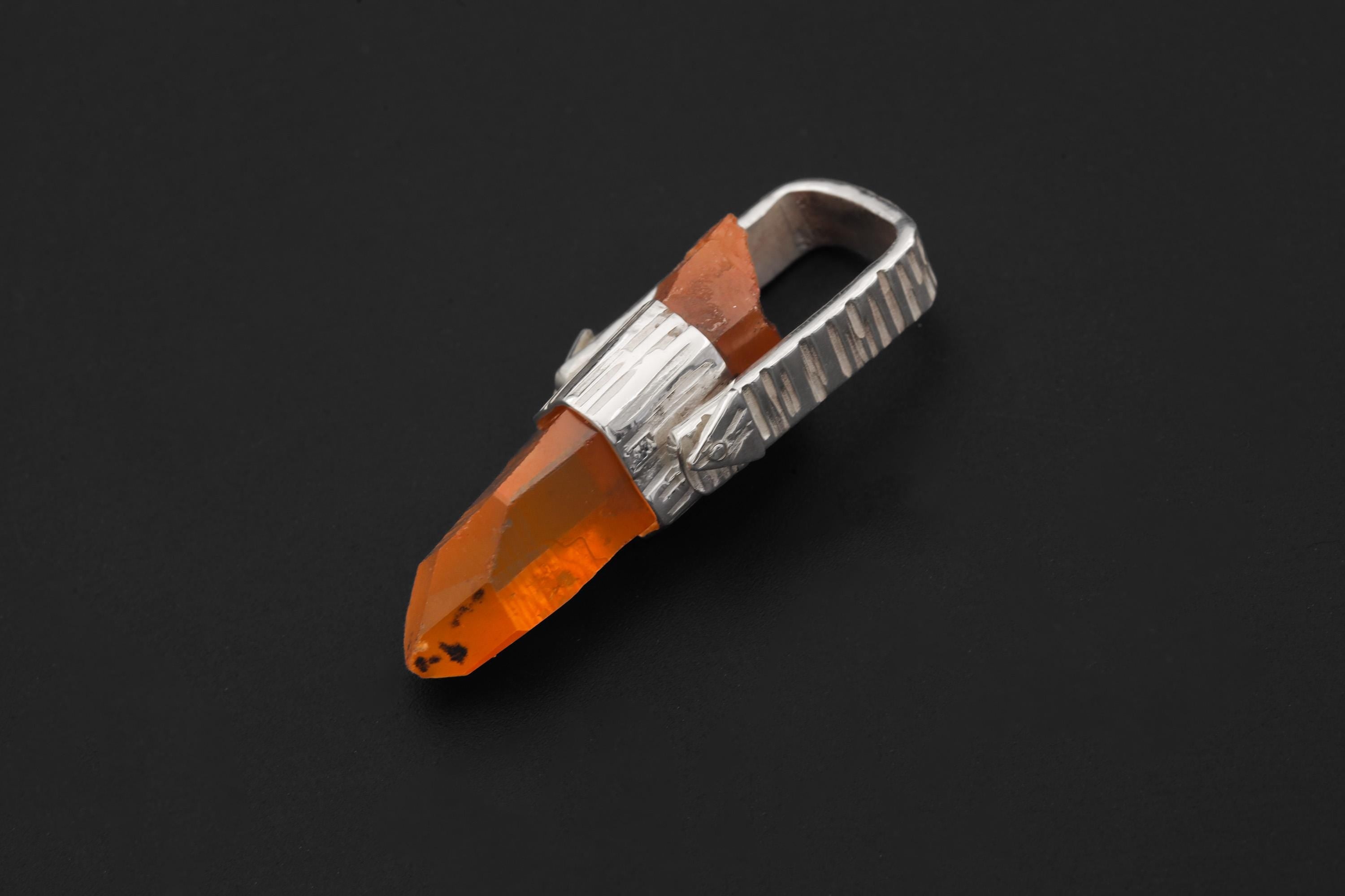 Australian Lemurian Quartz pendant shown worn on a model, with orange crystal point and high-shine sterling silver setting.