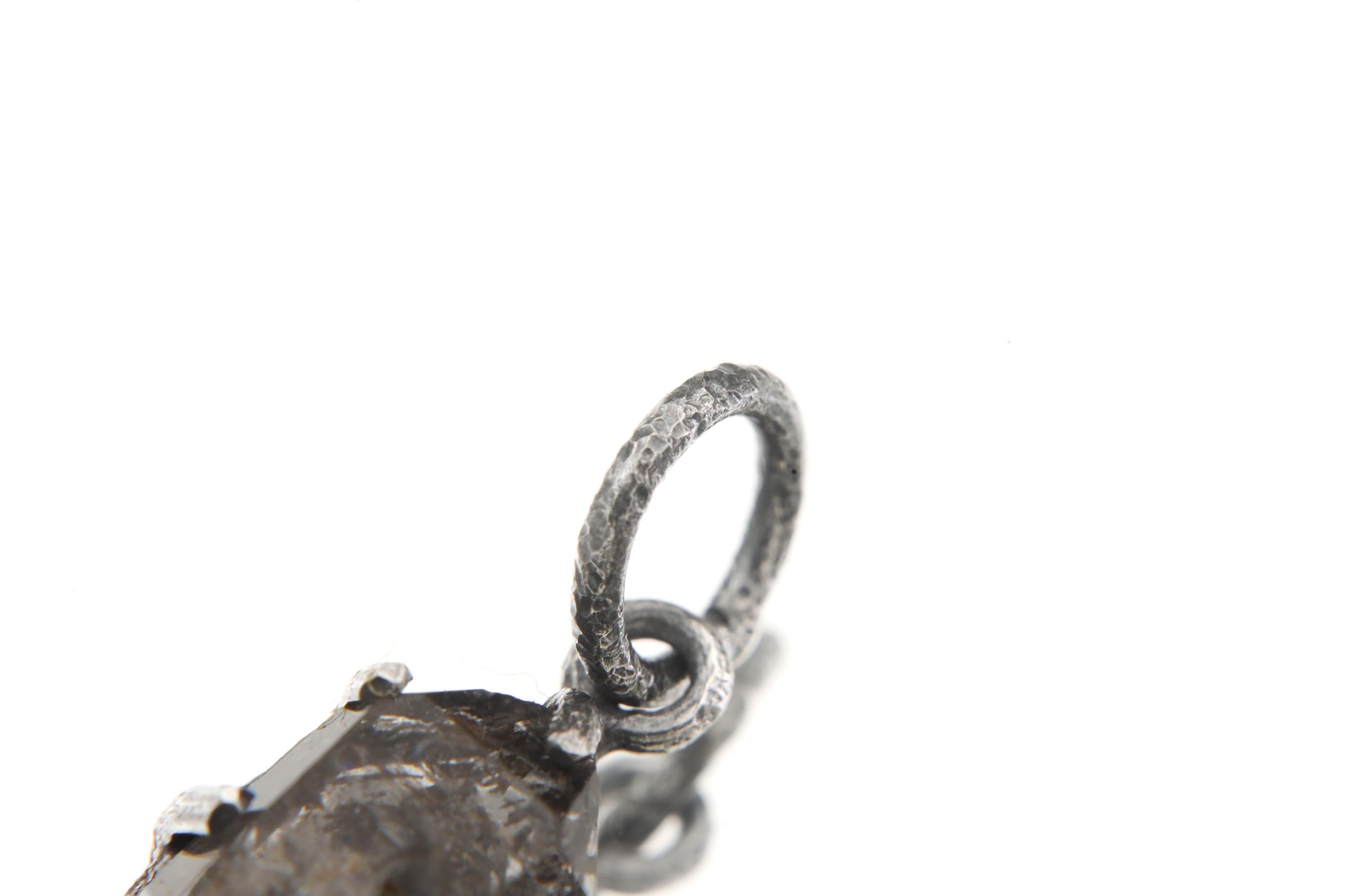 Close-up of oxidized sterling silver bail on a Tibetan Petroleum Inclusion Quartz pendant with hammered handmade texture.
