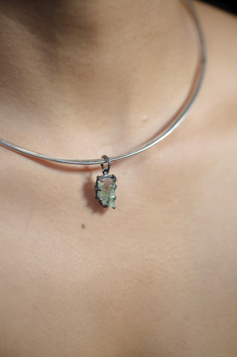 Watermelon Tourmaline pendant shown worn on a model, with compact oxidized silver setting and soft green pink crystal colour.