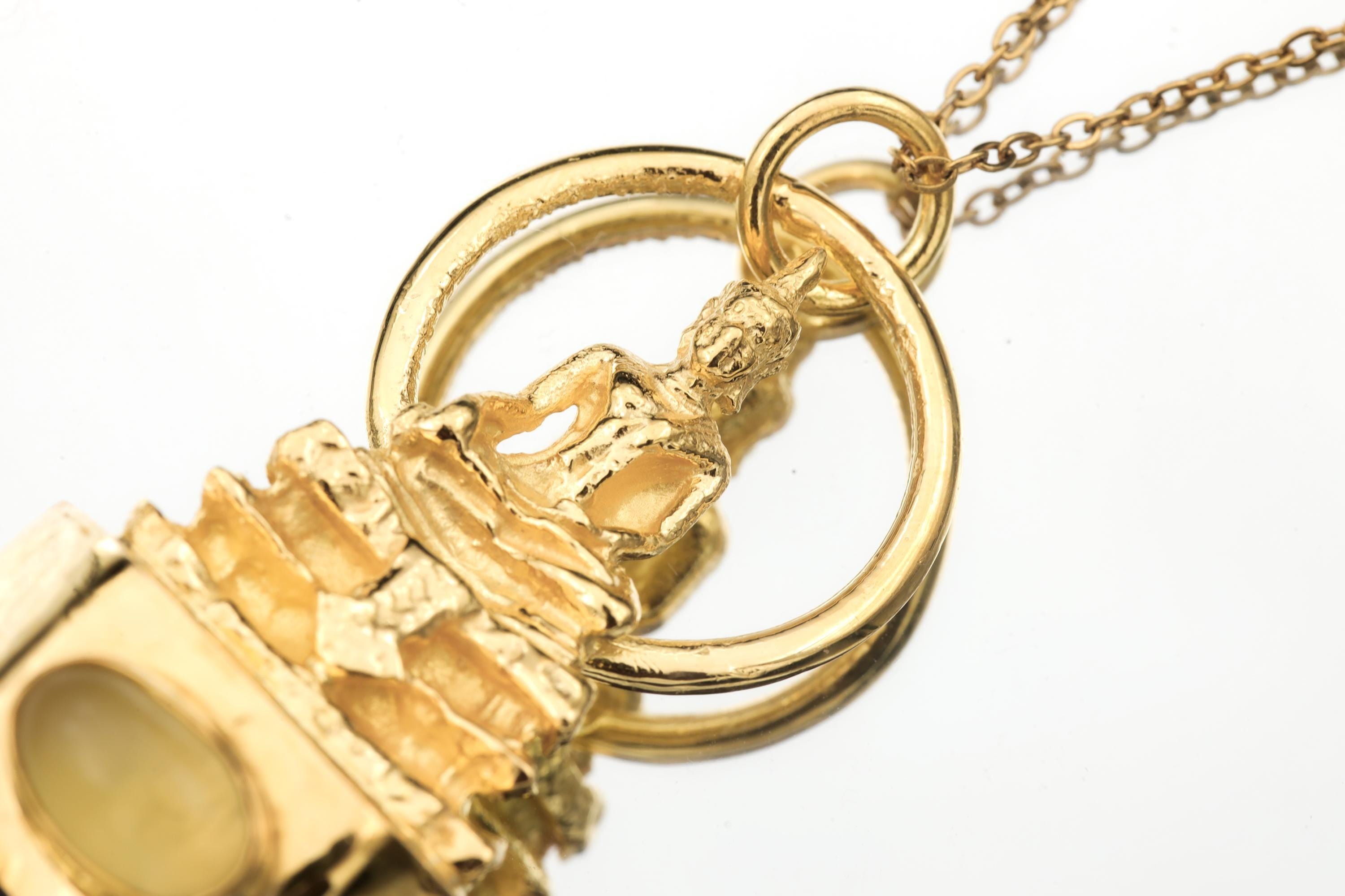 Close-up of cast brass Buddha and gold-plated looped bail above Ethiopian Opal and Smoky Quartz pendant setting.