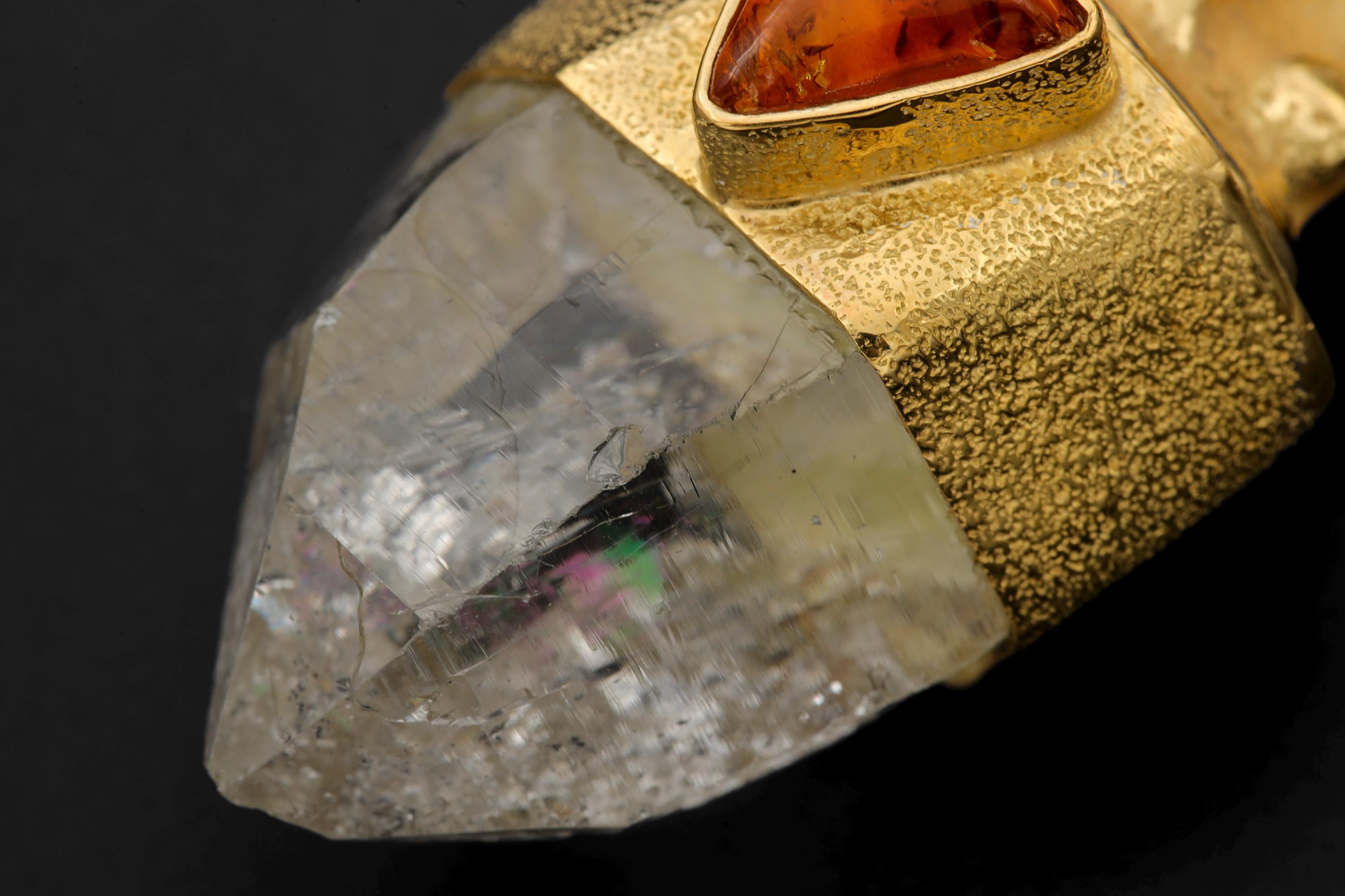 Side view of pendant revealing Lemurian striations, brushed gold texture, and smooth amber polish.