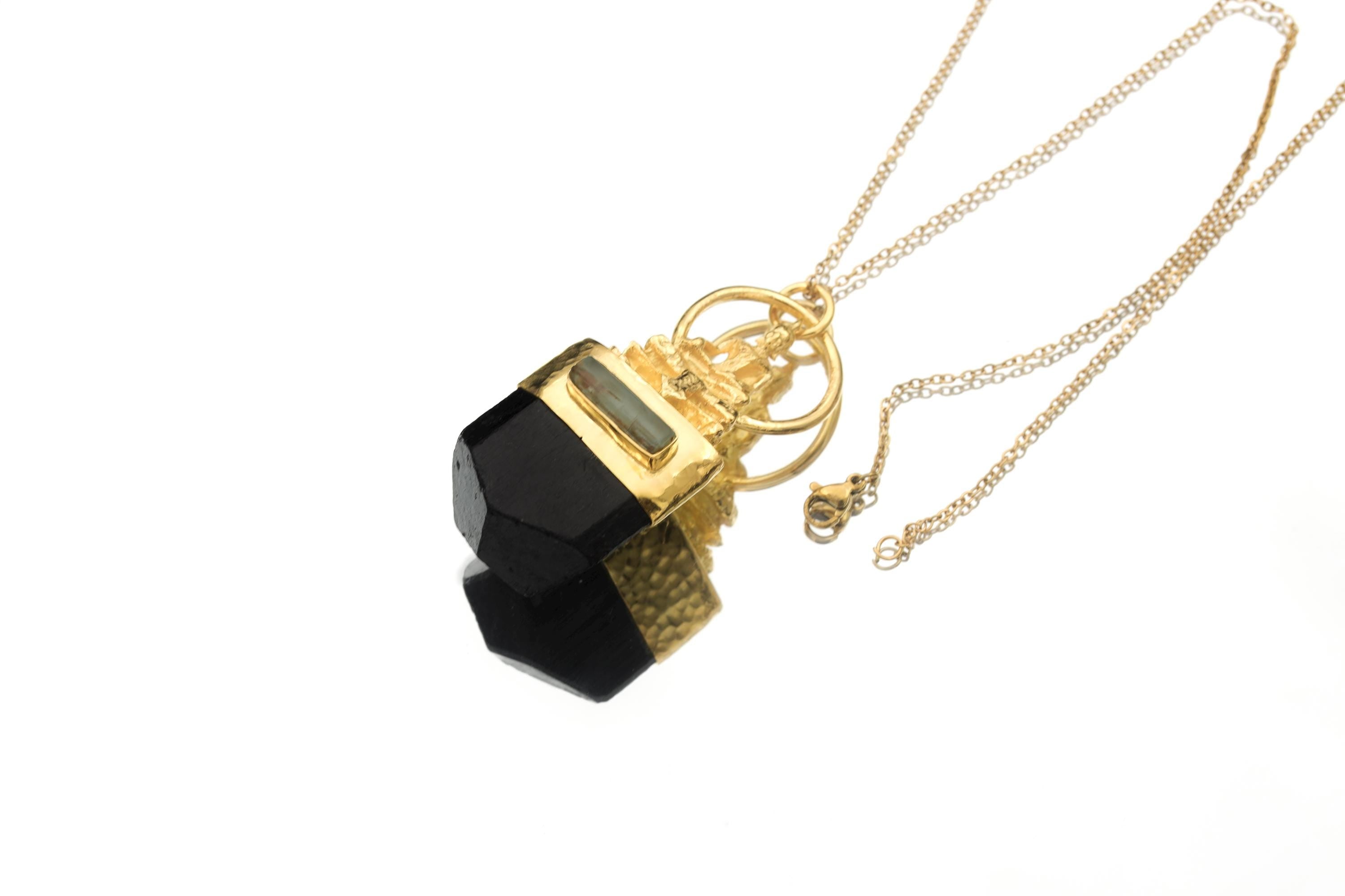 Black Tourmaline Buddha pendant shown on white background with Smoky Quartz inset and gold-plated detail.