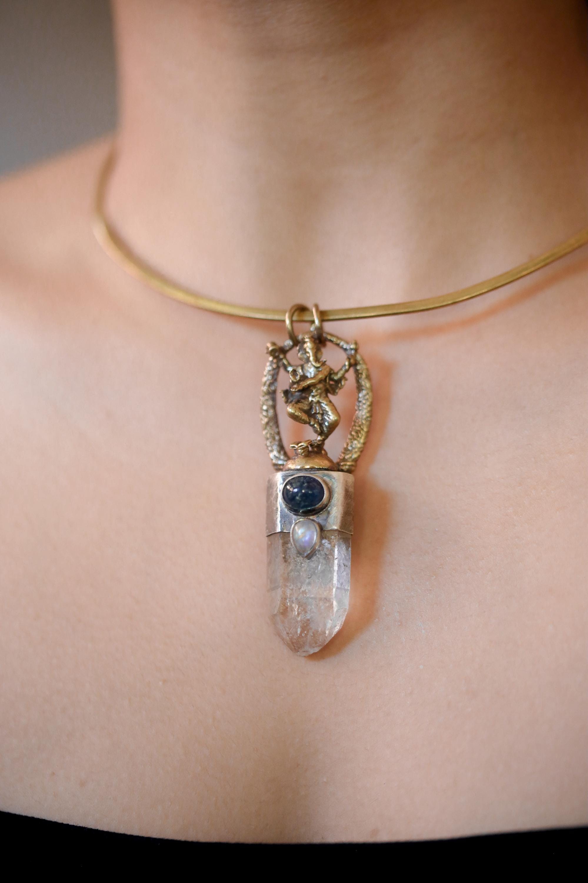 Side view of pendant on model showing depth of setting and layered stone arrangement.
