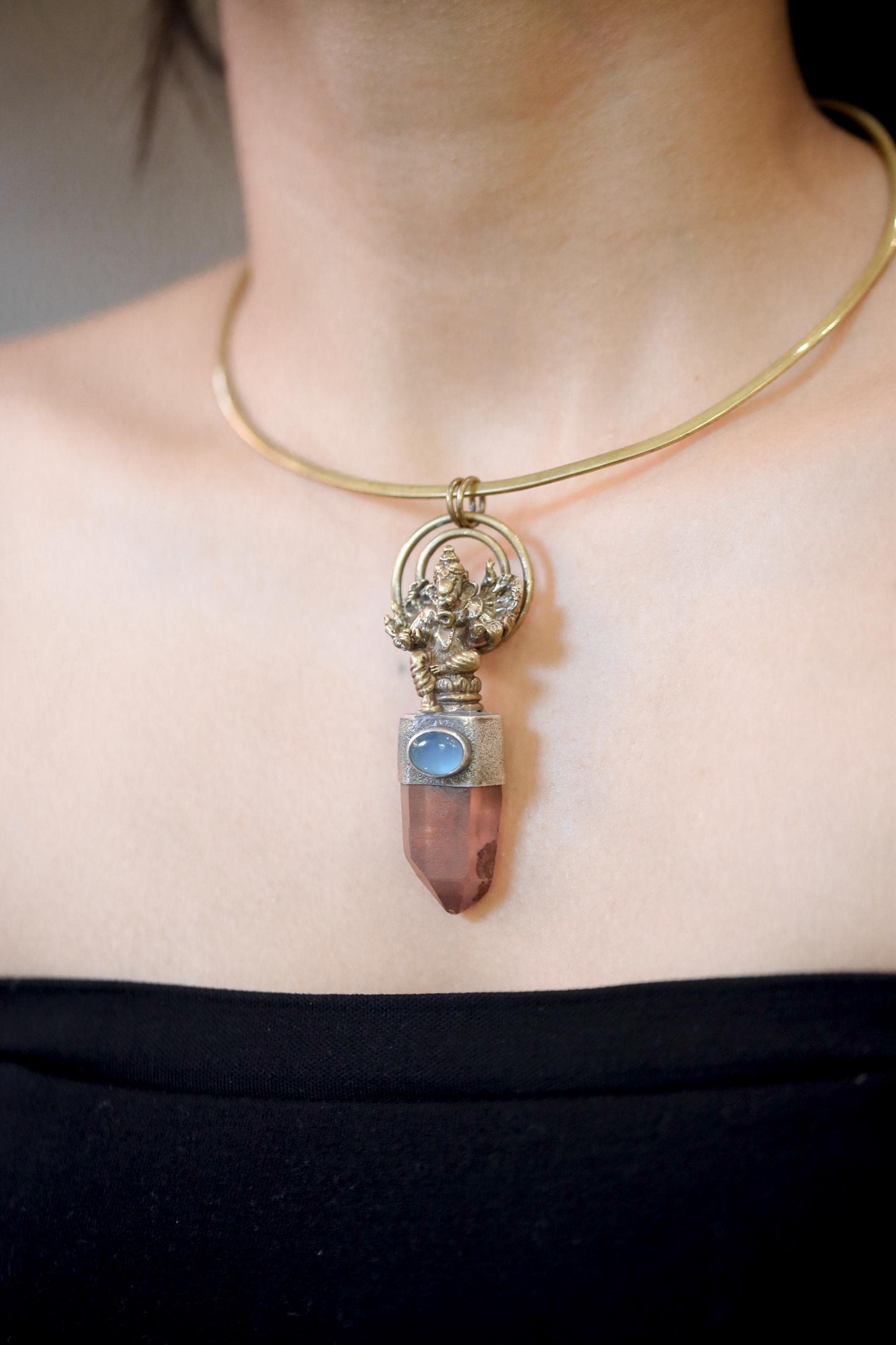 Pendant worn on model chest showing full length and warm earthy tones of quartz combined with cool Aquamarine hue.