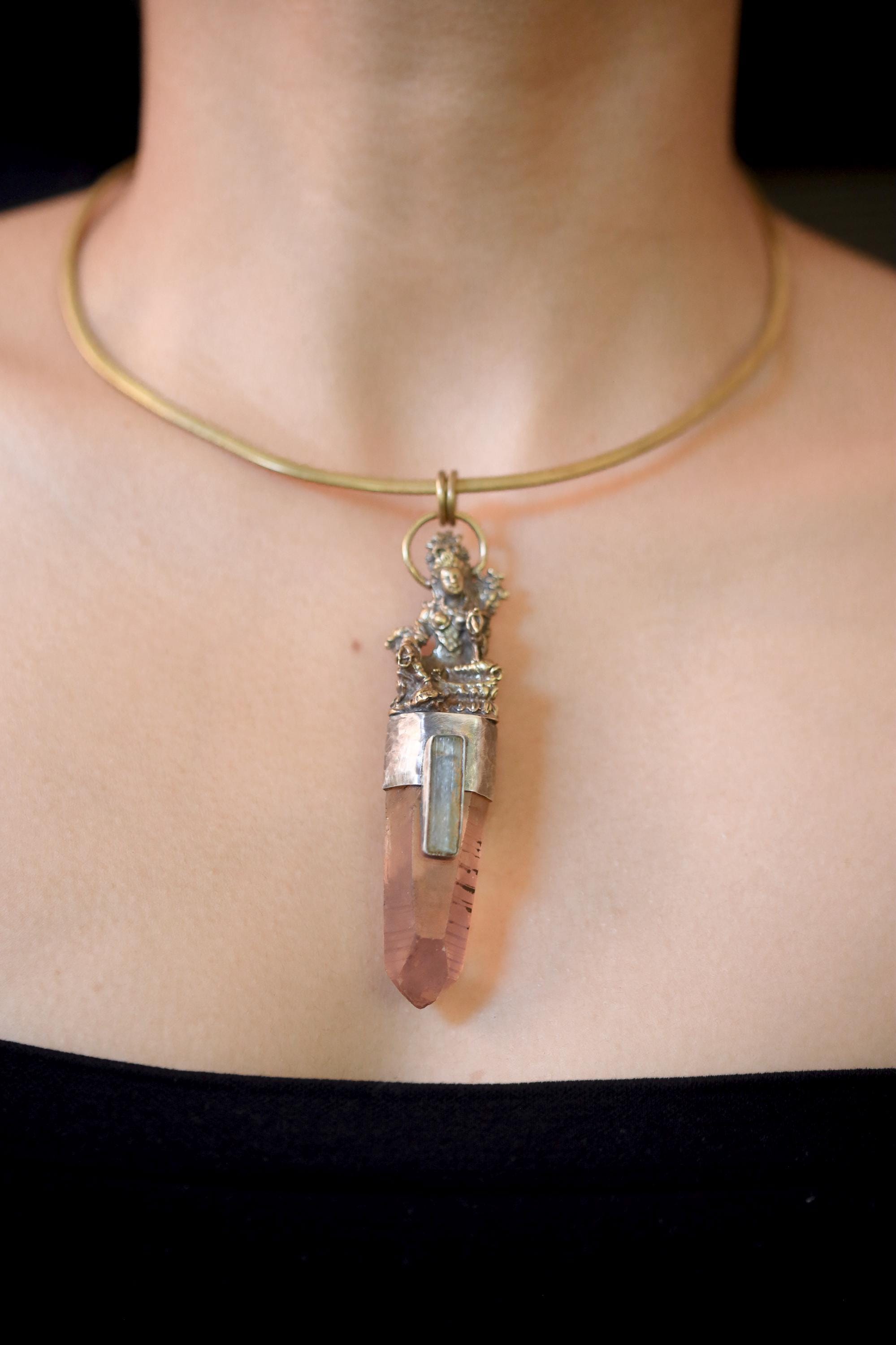 Pendant on model neckline showing proportional fit and earthy, celestial color harmony.