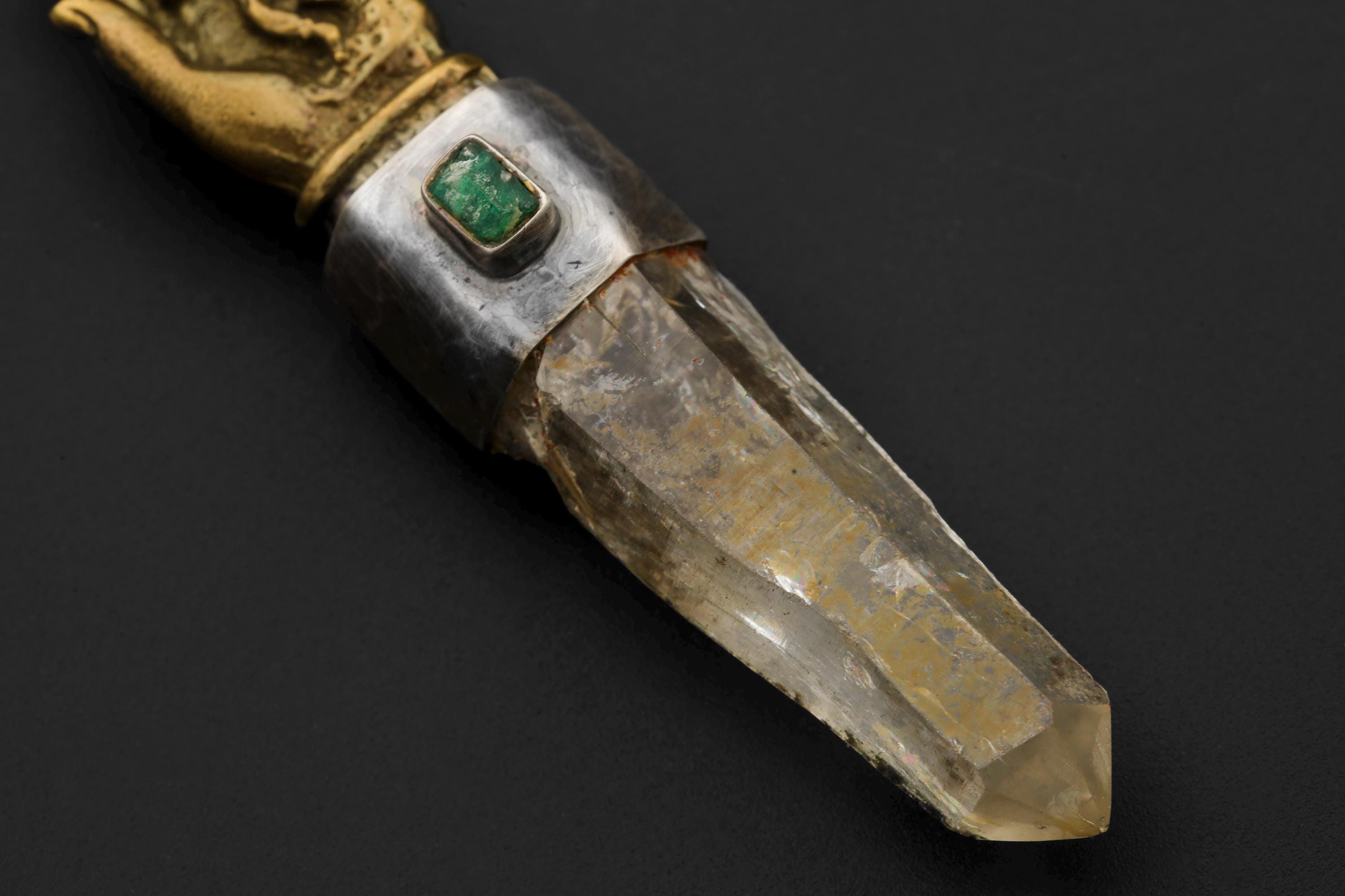 Macro detail of raw emerald bezel with visible inclusions and natural polish marks surrounded by oxidized silver frame.