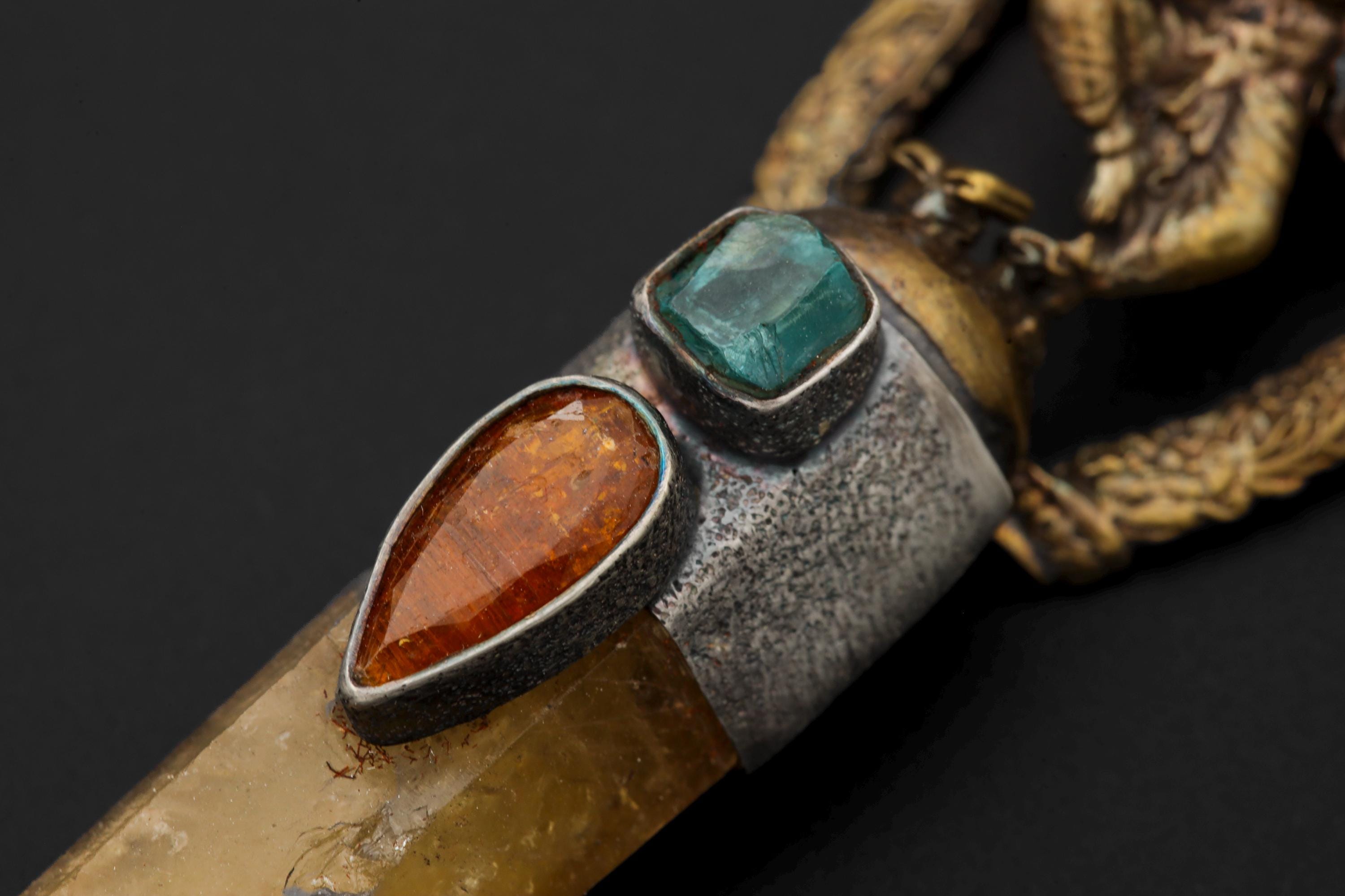 Pendant photographed from side angle showing raw Apatite’s crystalline structure within silver bezel.