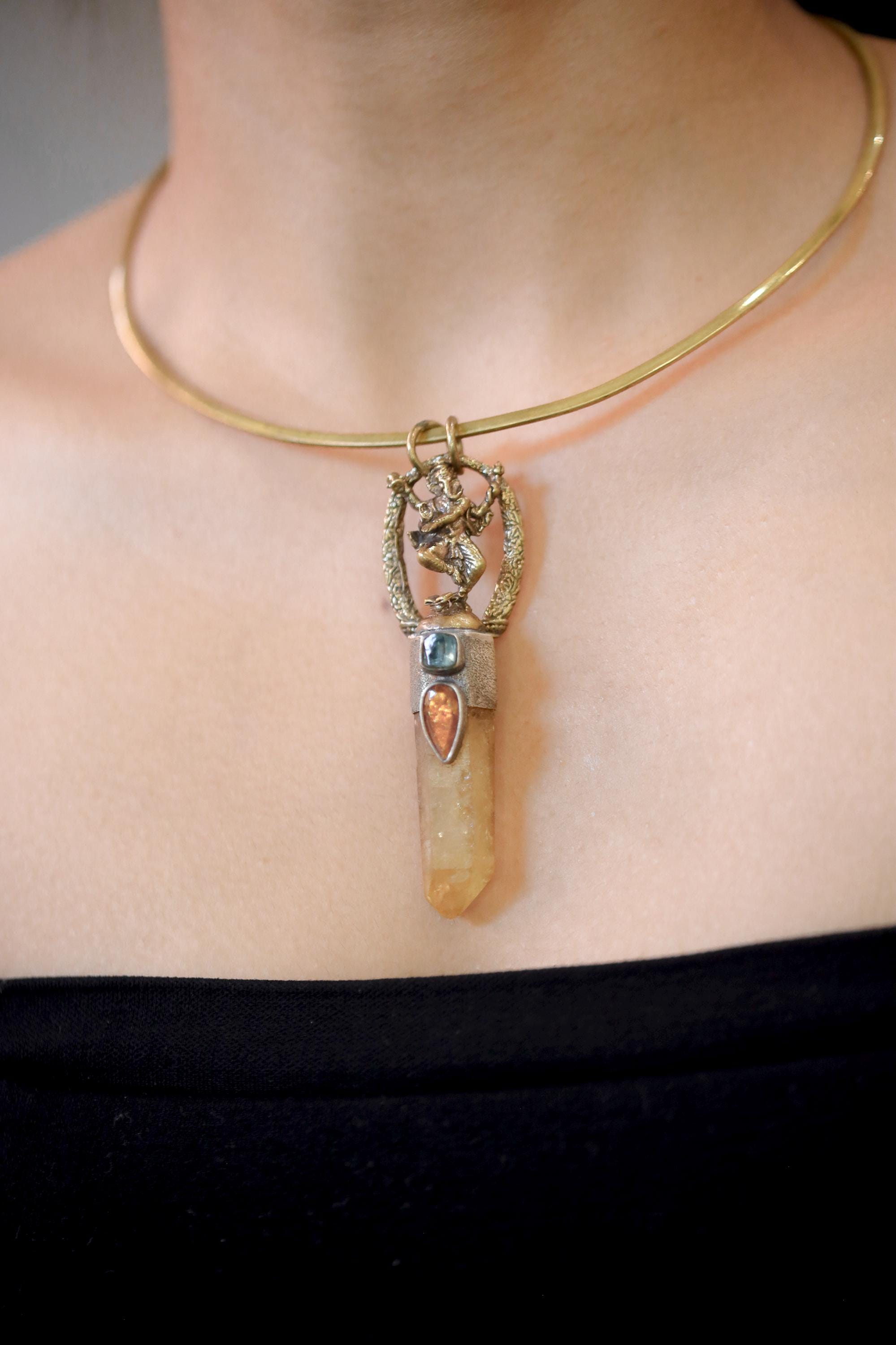 Pendant worn on model chest showing full pendant length, gemstone alignment, and mixed metal contrast.