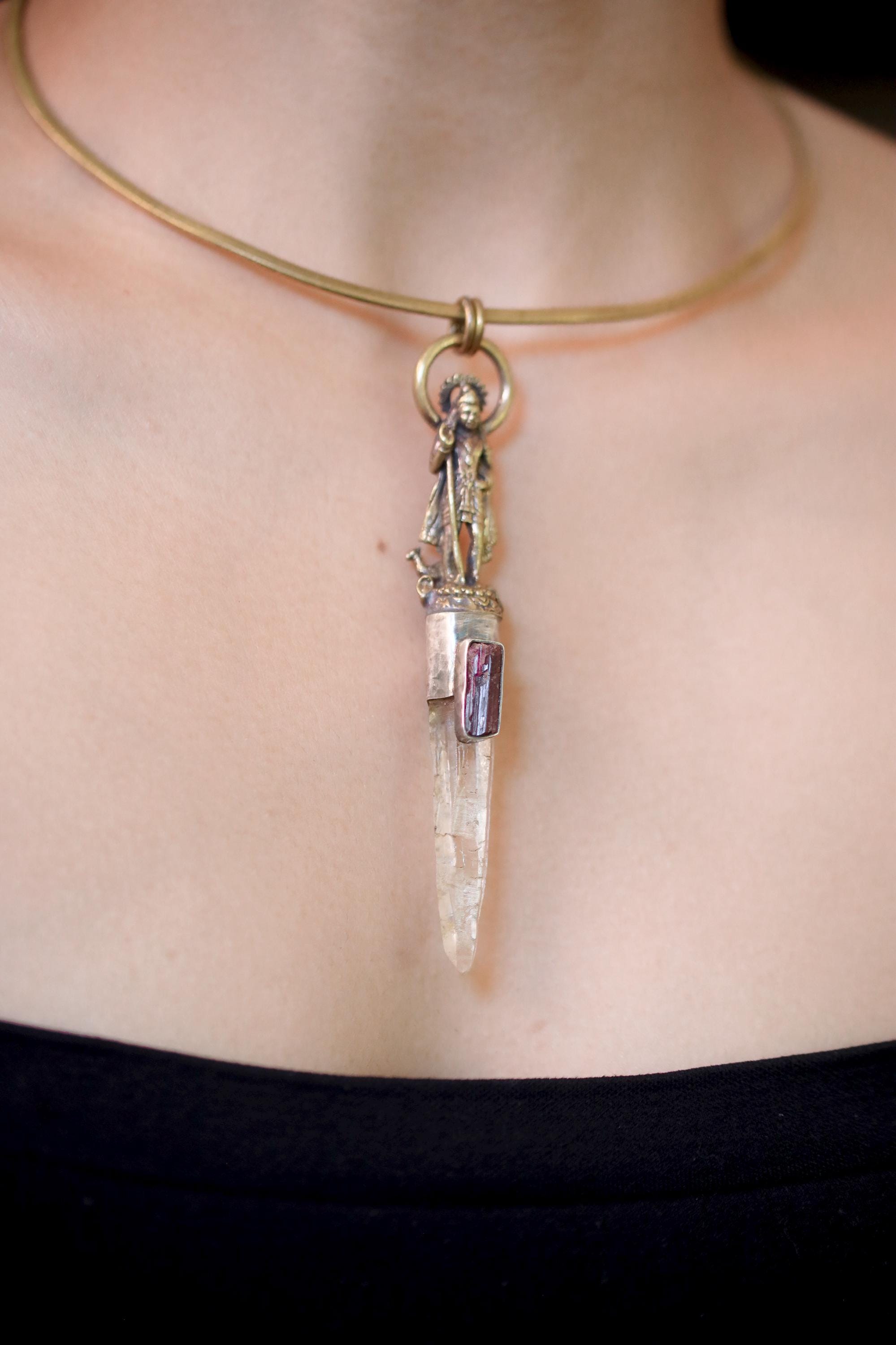Pendant on model upper chest in neutral lighting showing centered placement and spiritual design balance.