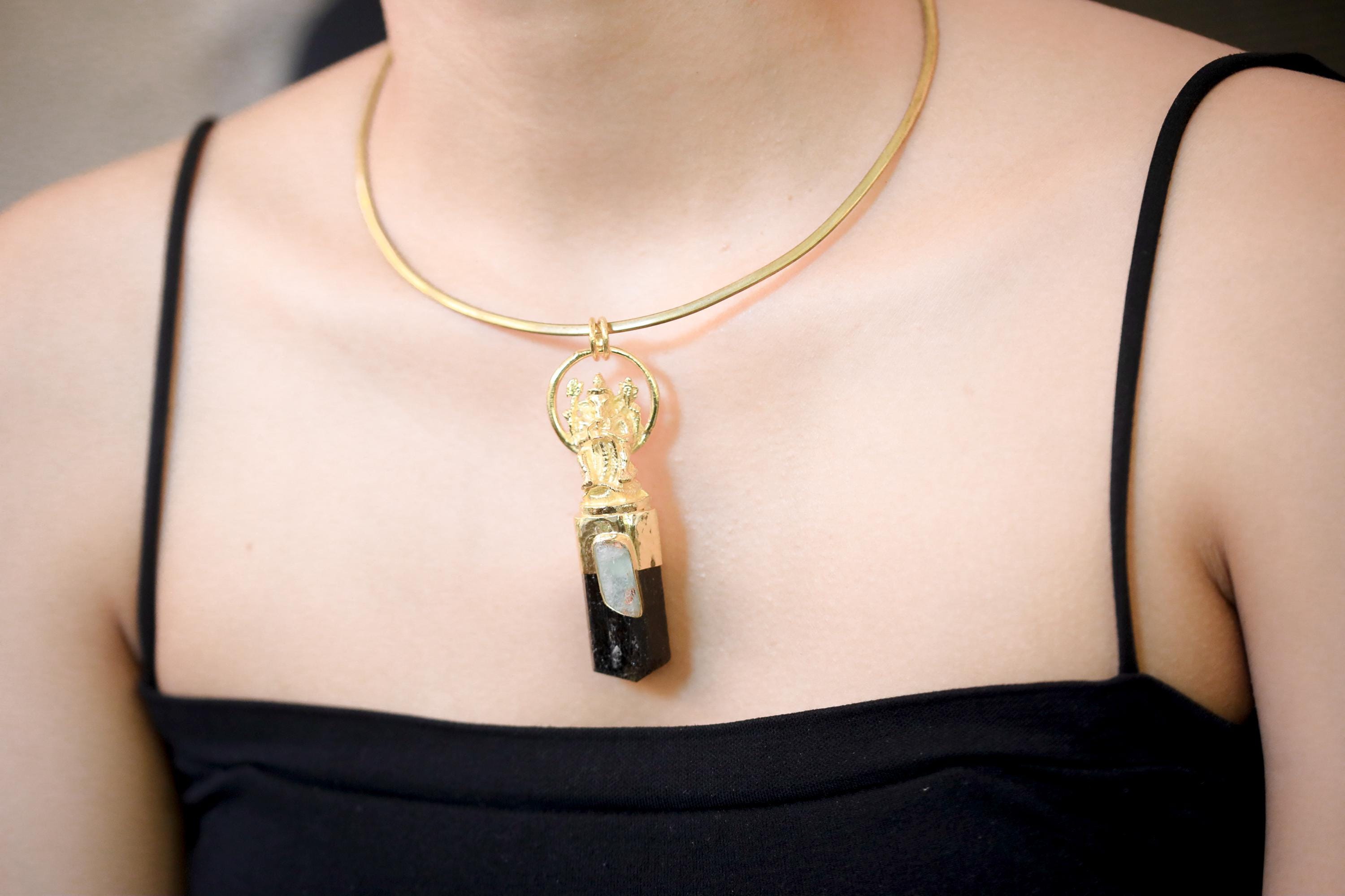 Pendant on model upper chest in neutral lighting showing centered position and visual balance.