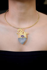Pendant worn on model chest highlighting pendant length, gemstone alignment, and radiant gold sheen under soft light.