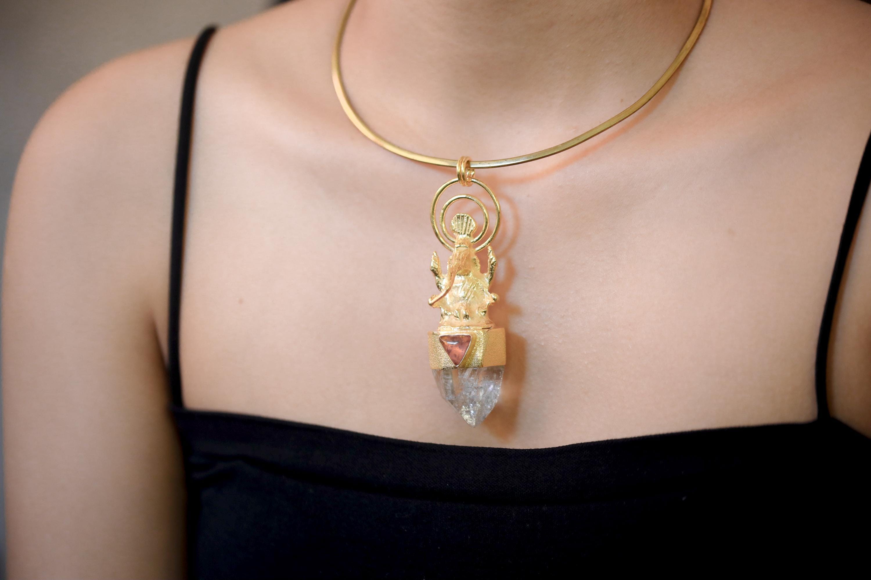 Pendant worn on model upper chest under daylight emphasizing the spiritual tone and depth of stone colors.