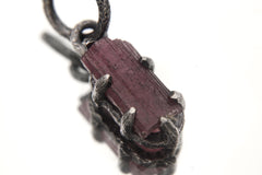 Pink Tourmaline Rubellite Wand Pendant on white background with oxidized sterling silver claw setting and deep rose crystal.