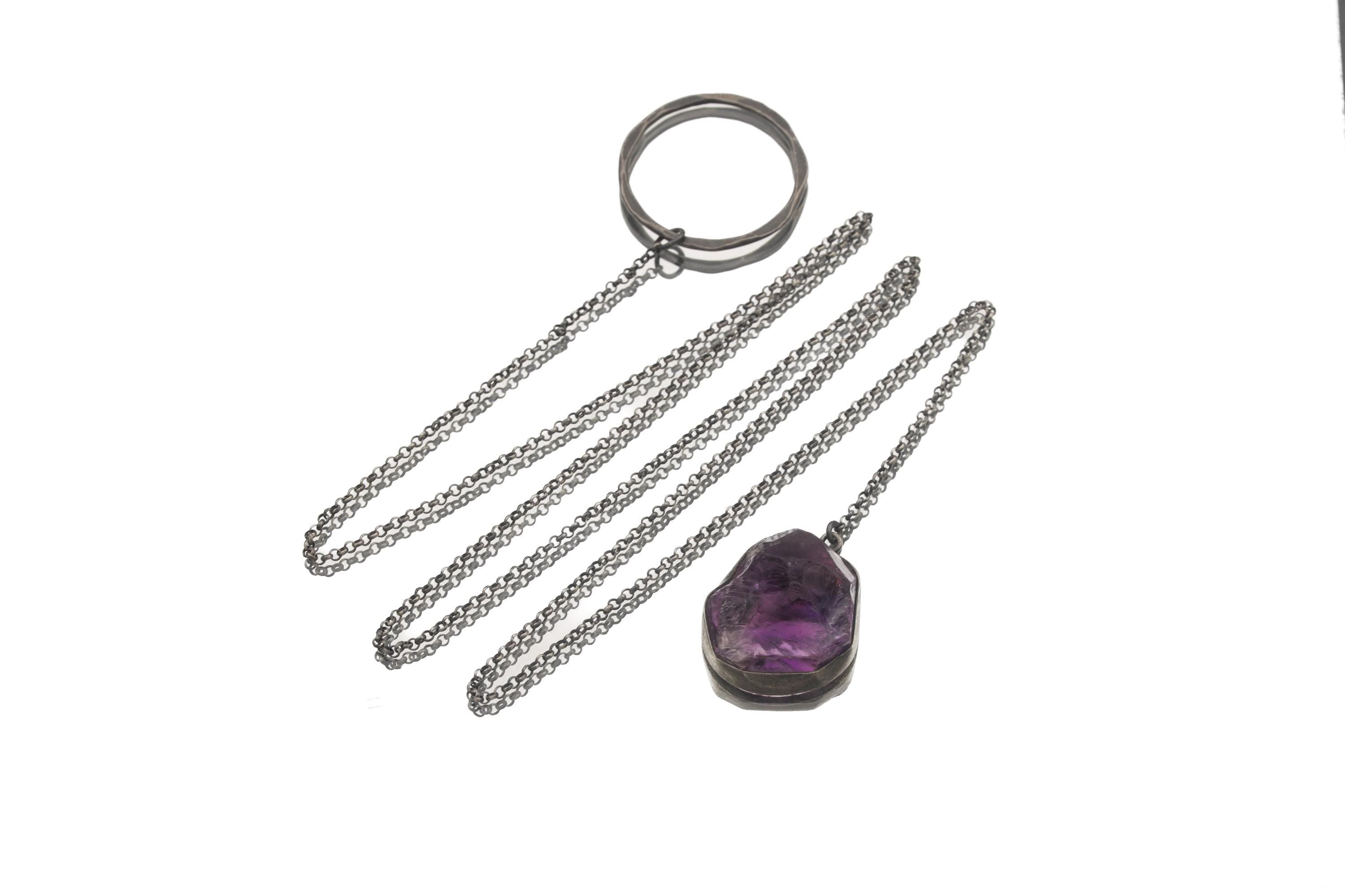 Raw Amethyst lariat necklace displayed on white background with textured silver loop and long chain.