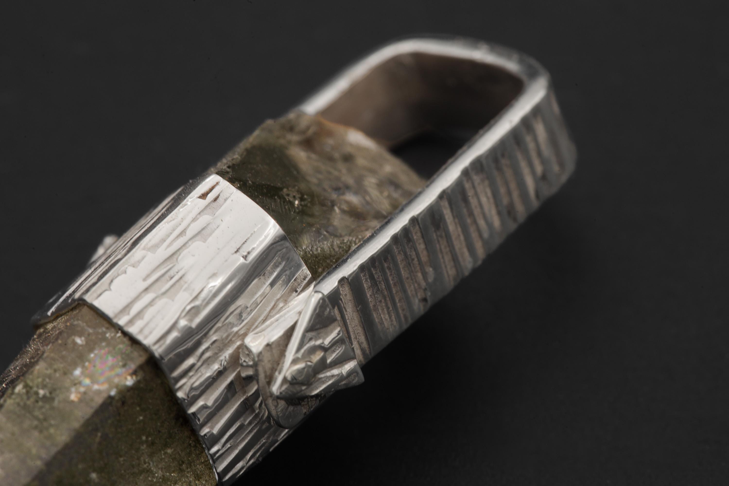Close-up of Himalayan Lemurian Quartz point showing chlorite misting, golden rutile threads, and natural crystal termination.
