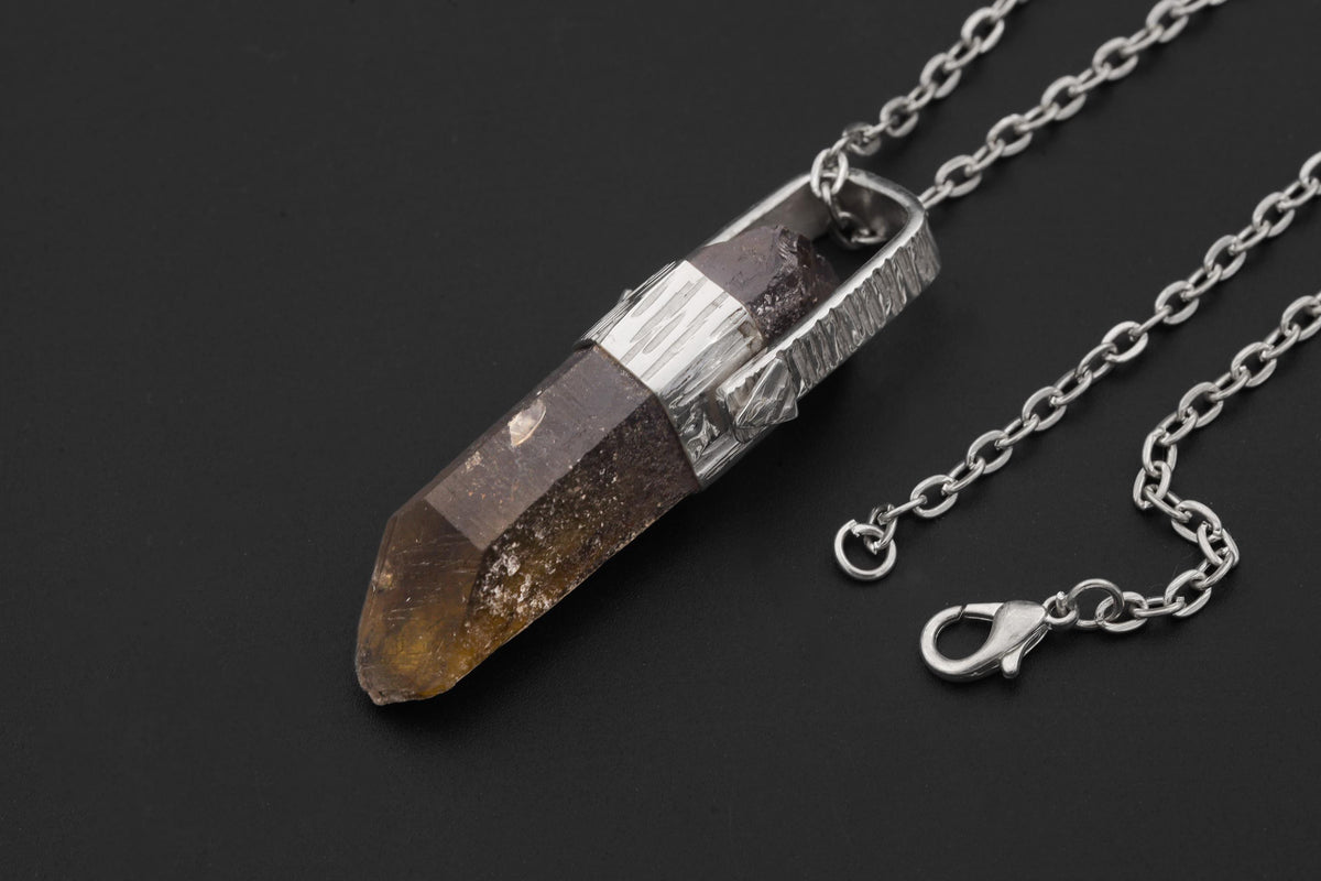 Australian Record Keeper Citrine Quartz pendant shown on black background with chain, high-polish sterling silver wrap, and golden crystal point.