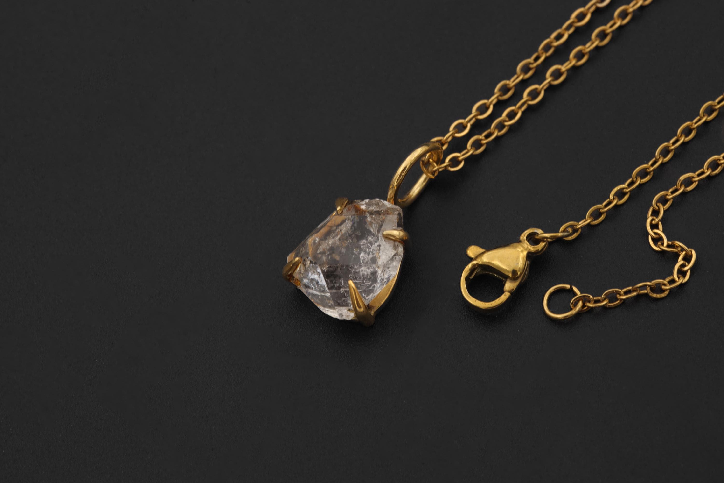 Herkimer Diamond Quartz pendant shown with adjustable necklace chain on black background.