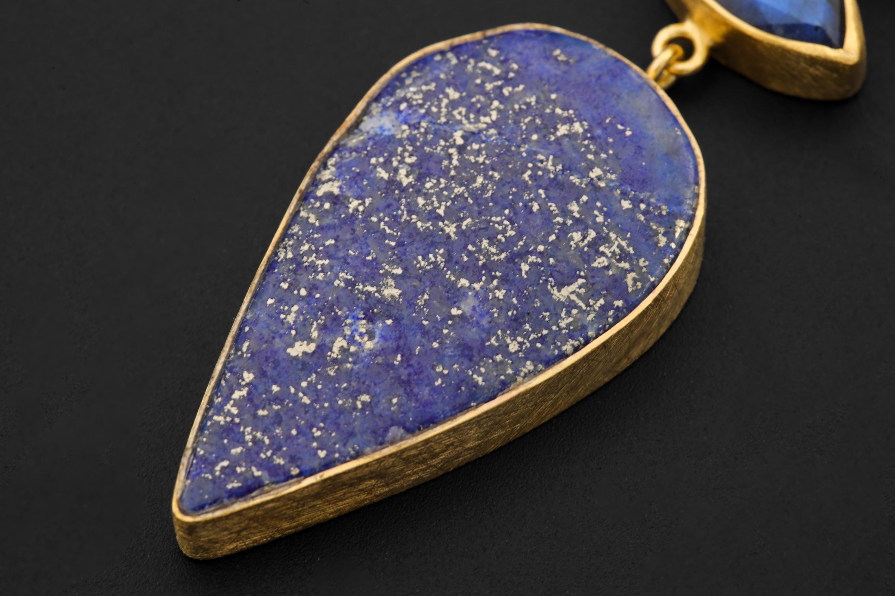 Close-up of old cut Pyrite-rich Lapis Lazuli pendant stone with deep indigo colour and golden flecks in gold-plated silver.