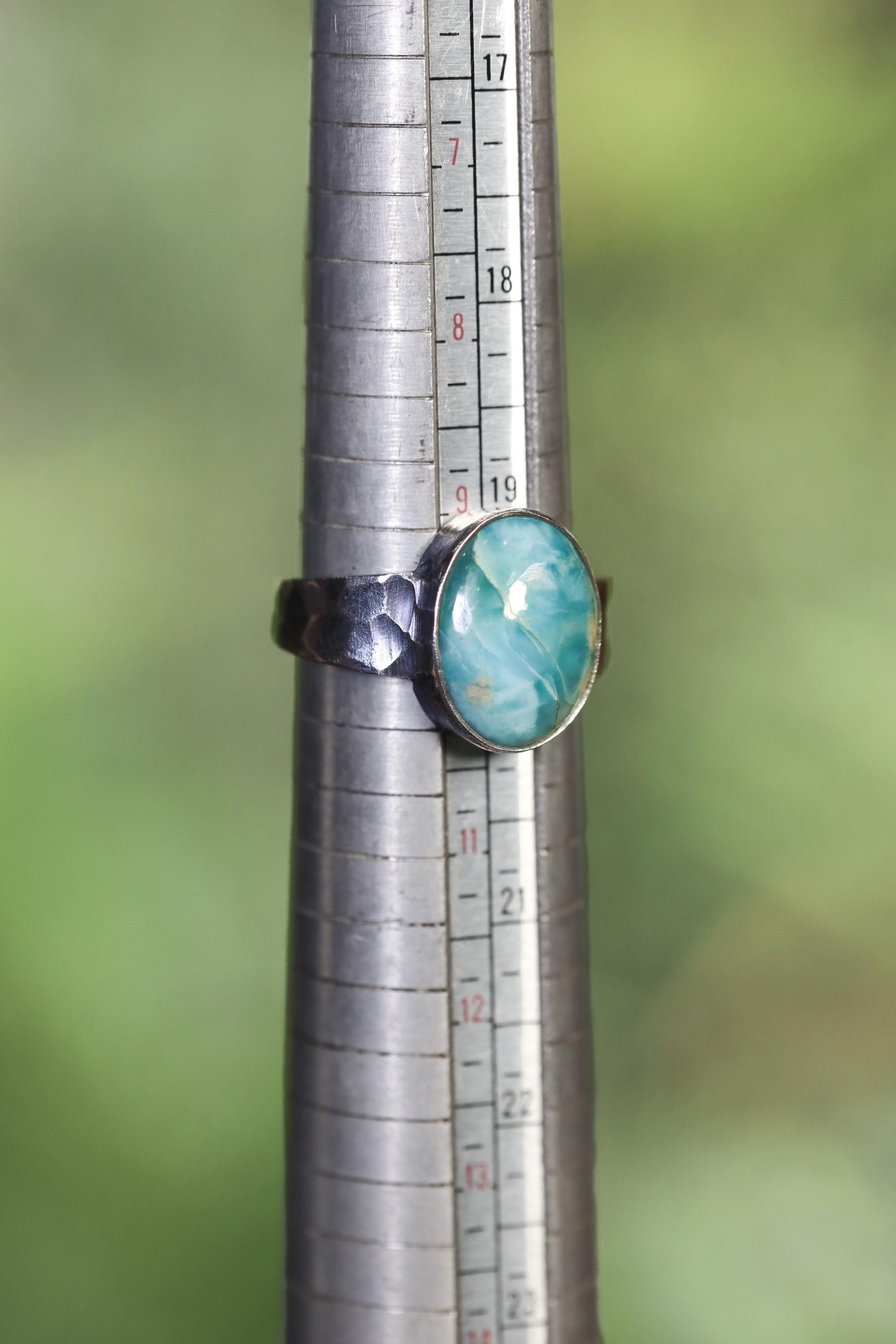 AAA Larimar men’s ring shown beside a ruler for scale, with fixed US size 10 band and hammered 925 silver setting.