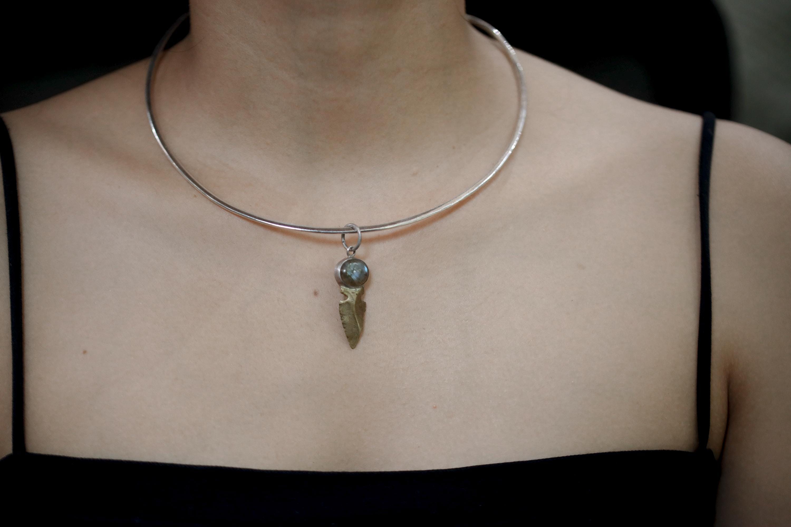 Labradorite Obsidian spearhead pendant shown on model as a symbolic protection necklace.