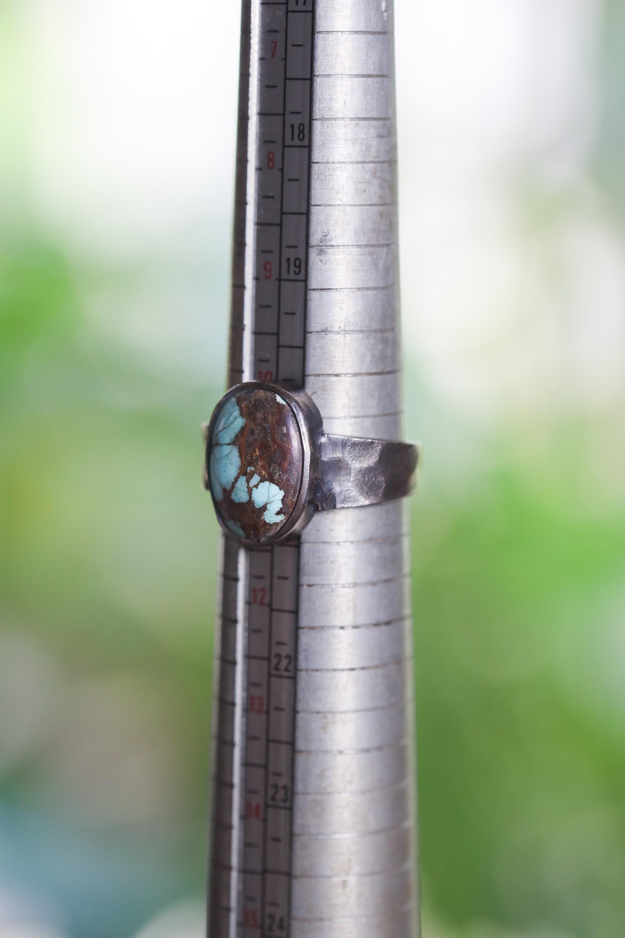 Tibetan Turquoise ring shown beside a ruler for scale, with fixed US size 11 band and oxidized sterling silver setting.