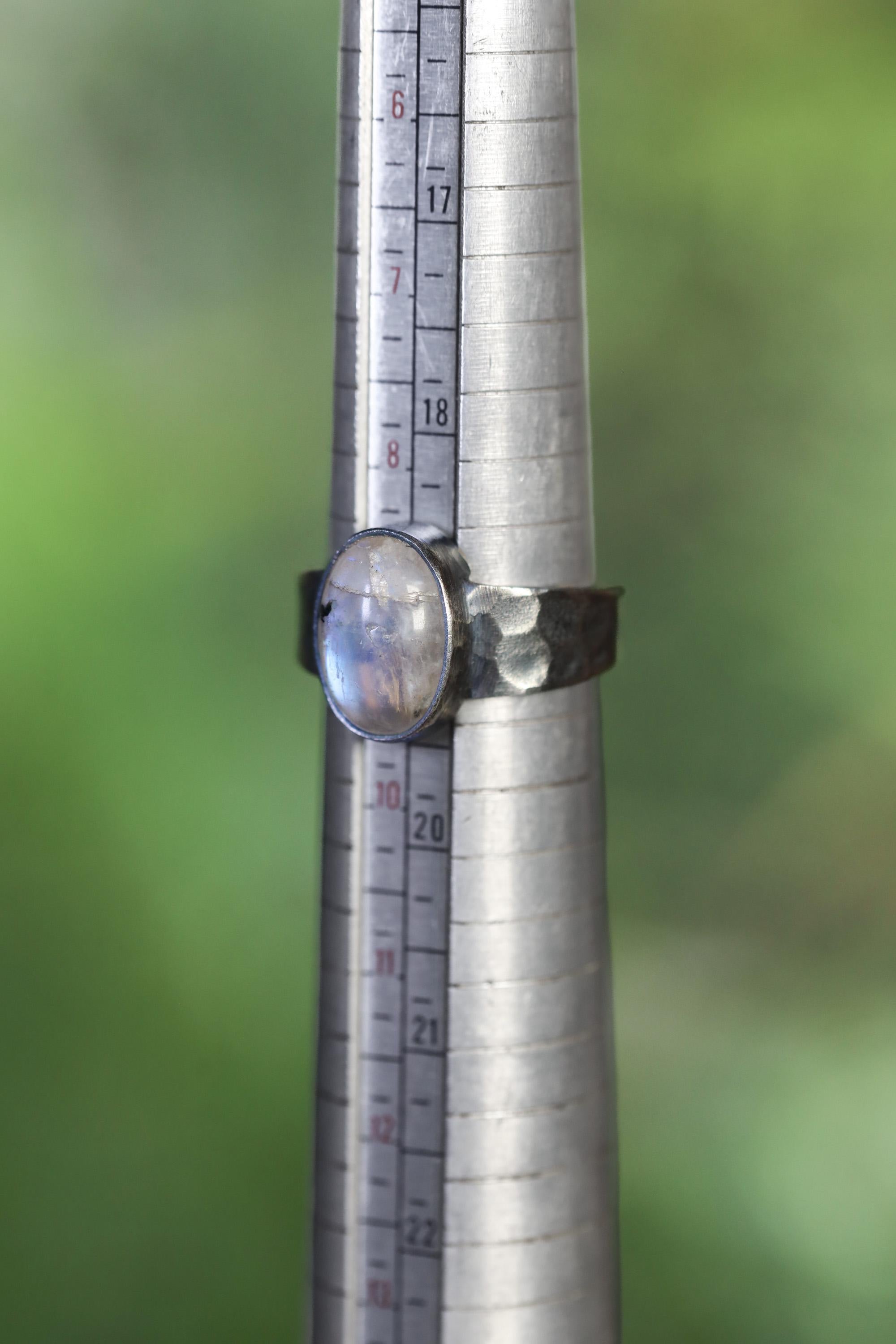 Blue Moonstone men’s ring shown beside a ruler for scale, with oxidized 925 sterling silver and fixed US size 9 band.