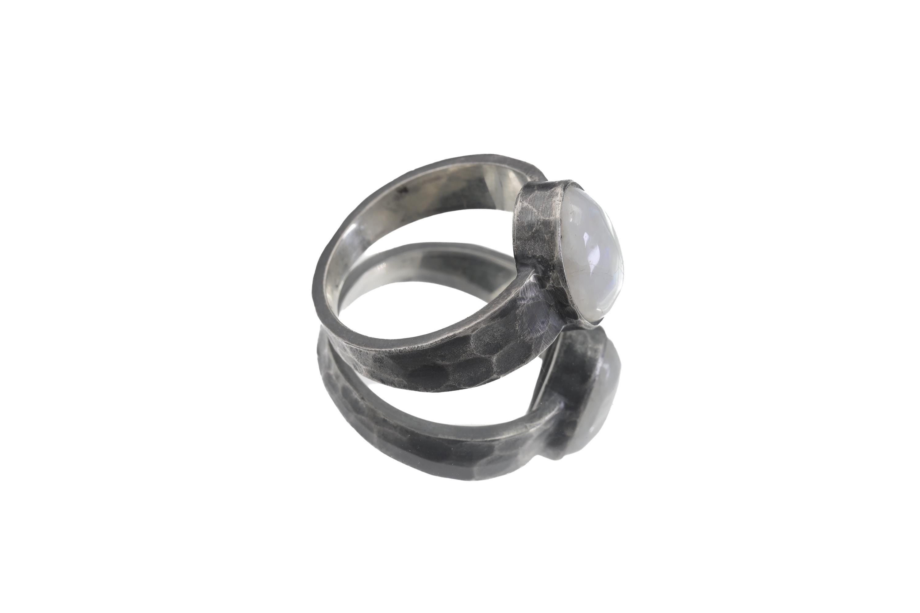 Side view of Blue Moonstone men’s ring showing wide oxidized sterling silver band and grounded bezel setting.