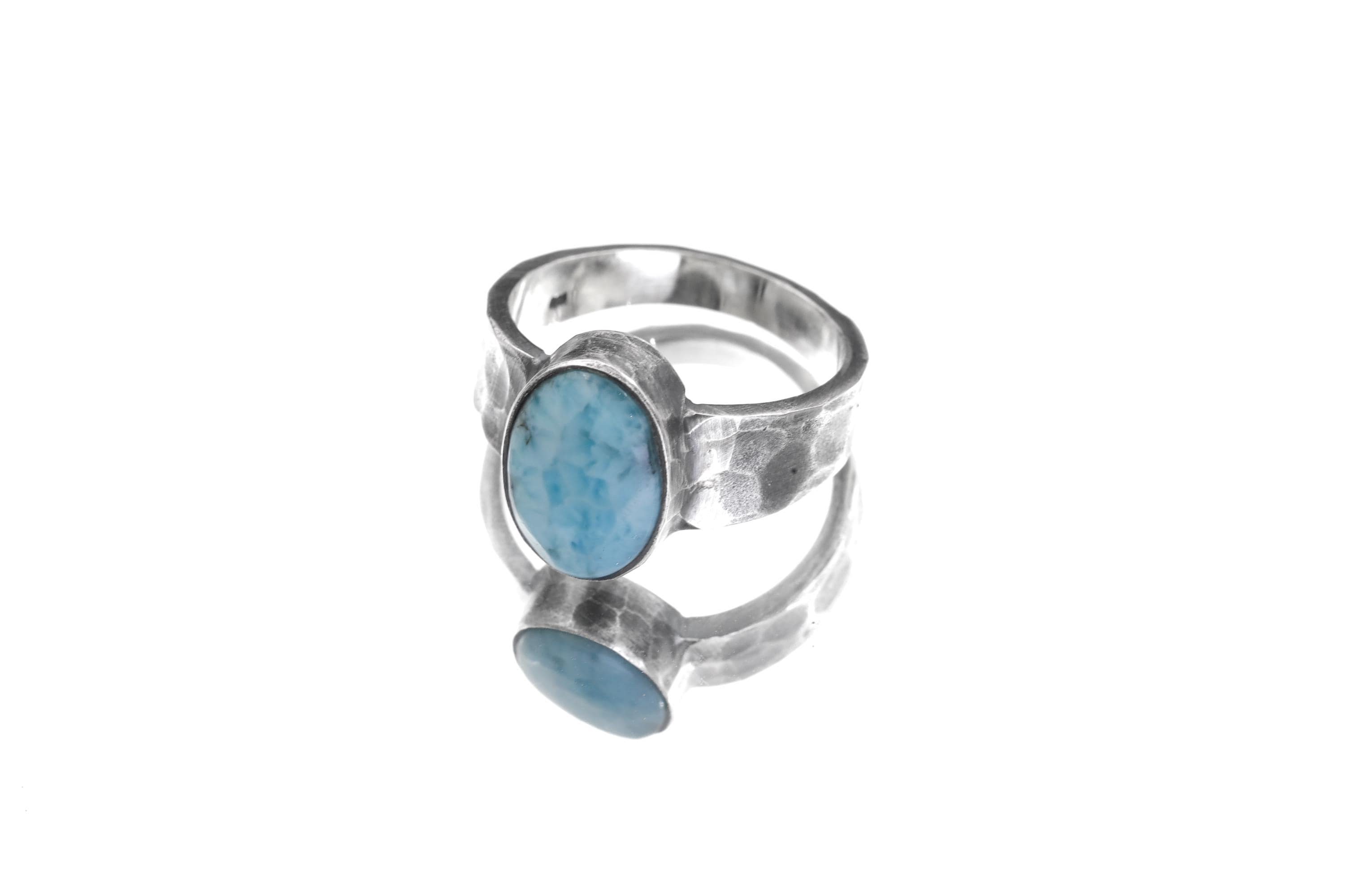 AAA Larimar ring displayed on white background with broad handmade sterling silver band.