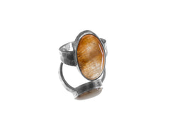 Gold Rutilated Quartz ring displayed on white background with oxidized hammered sterling silver setting.