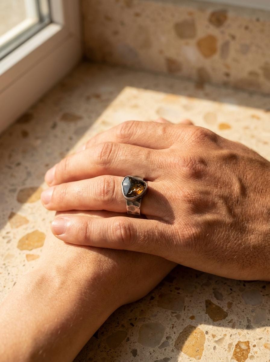 Freeform Green Tourmaline ring shown worn on the hand, with oxidized hammered silver and strong mineral presence.