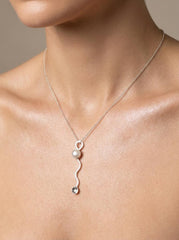 South Sea Pearl wavy spoon pendant shown worn on a model, with sterling silver chain and small sculptural spoon form.