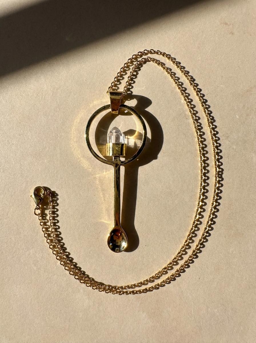 Lemurian Quartz gold-plated brass spoon pendant shown with chain, highlighting abstract bail and ritual pendant form.