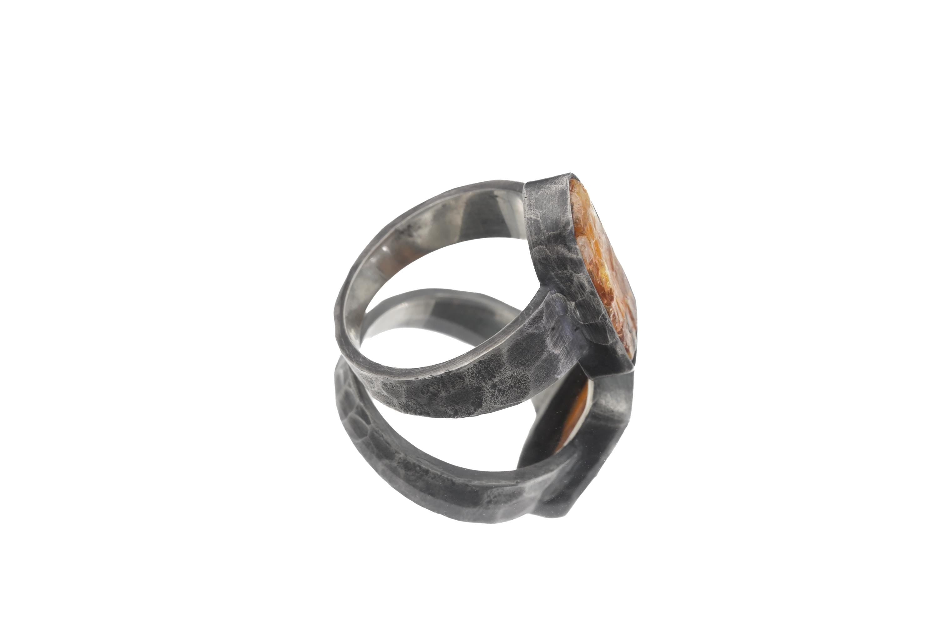 Side view of Orange Kyanite ring showing hand-formed bezel, rugged hammered band, and oxidized sterling silver.