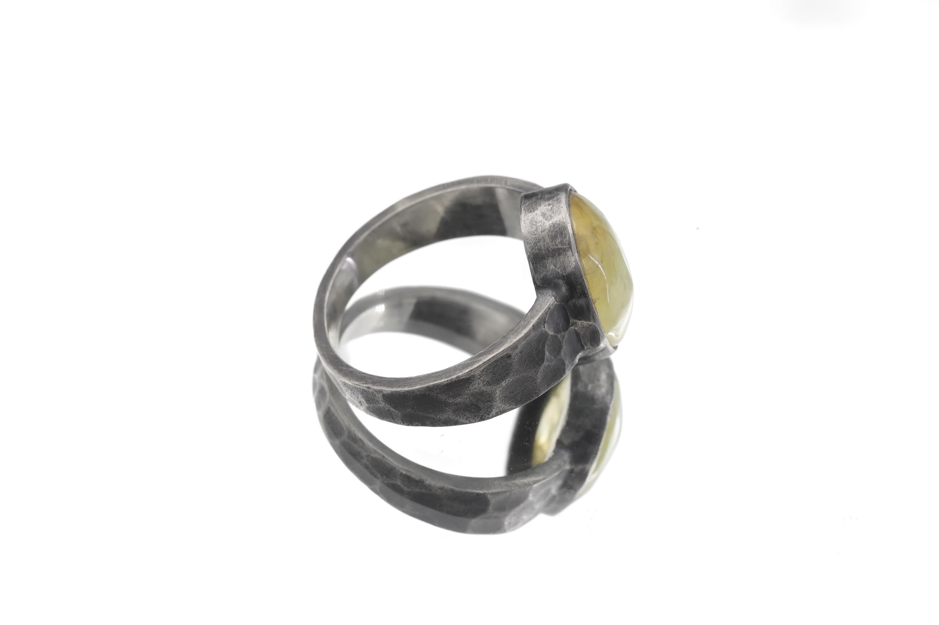 Side view of Australian Prehnite ring showing hammered oxidized sterling silver band and oval green gemstone setting.