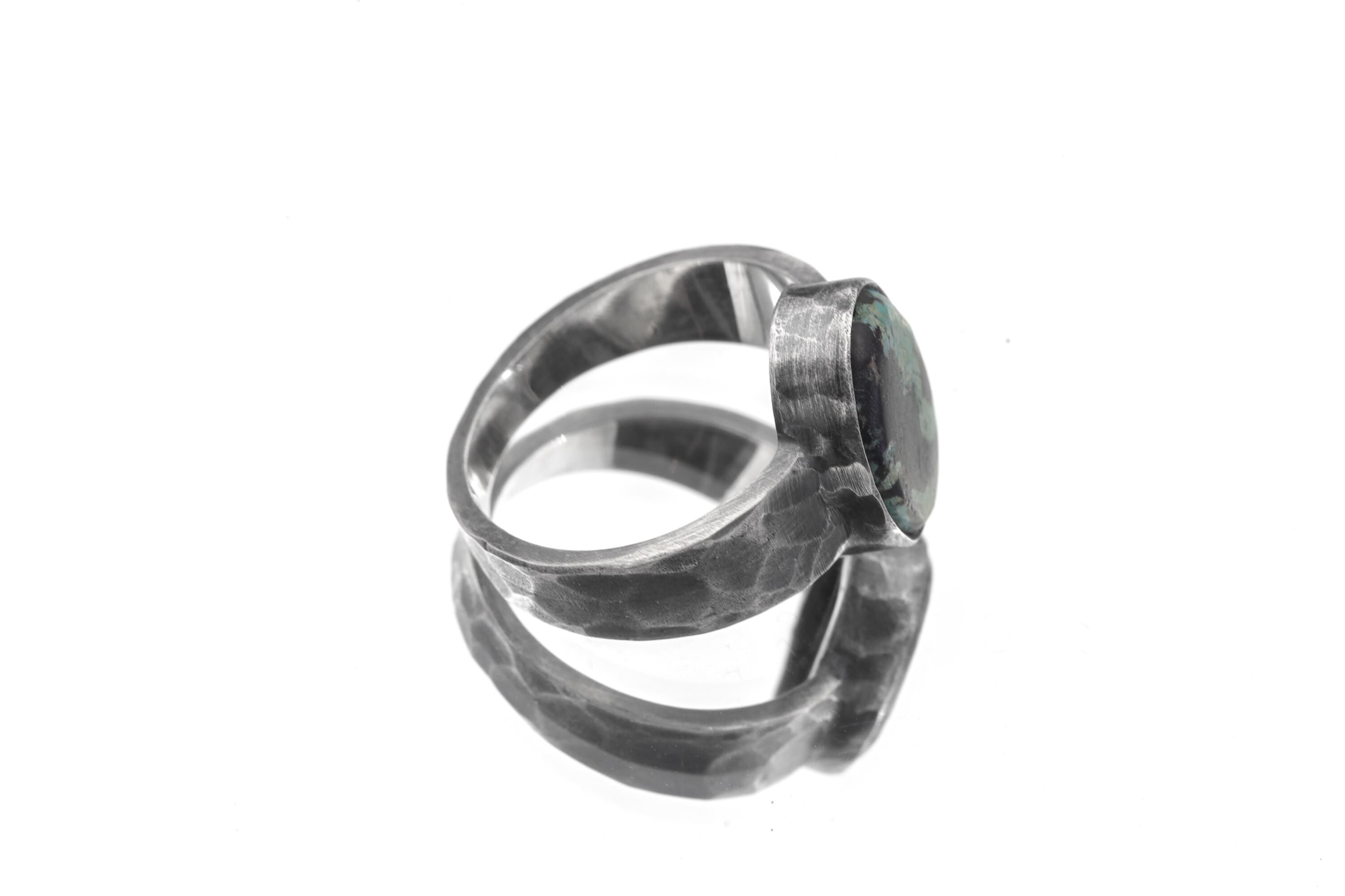 Side view of Old World Tibetan Turquoise ring showing wide hammered sterling silver band and thick bezel setting.