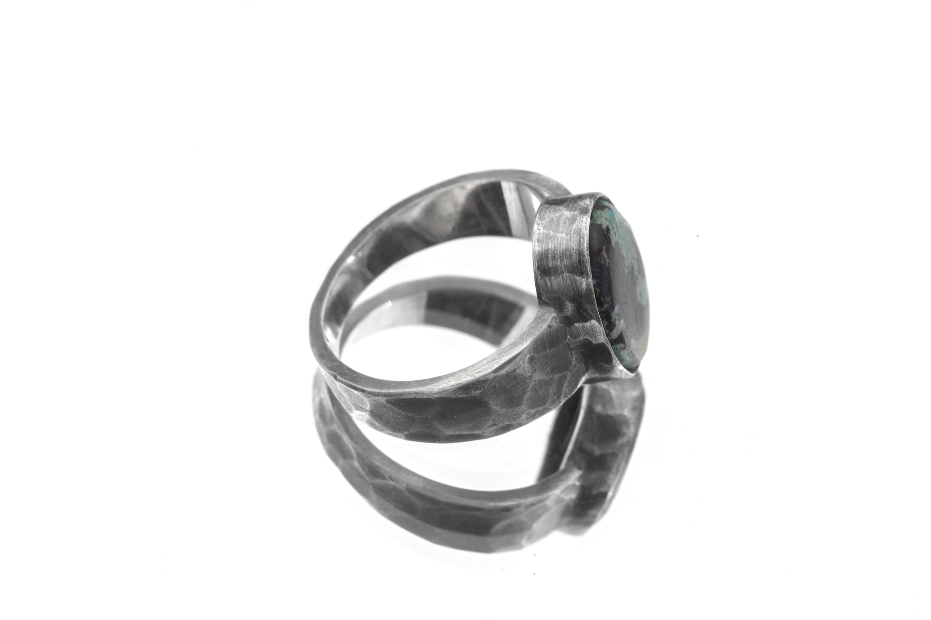 Side view of Old World Tibetan Turquoise ring showing wide hammered sterling silver band and thick bezel setting.