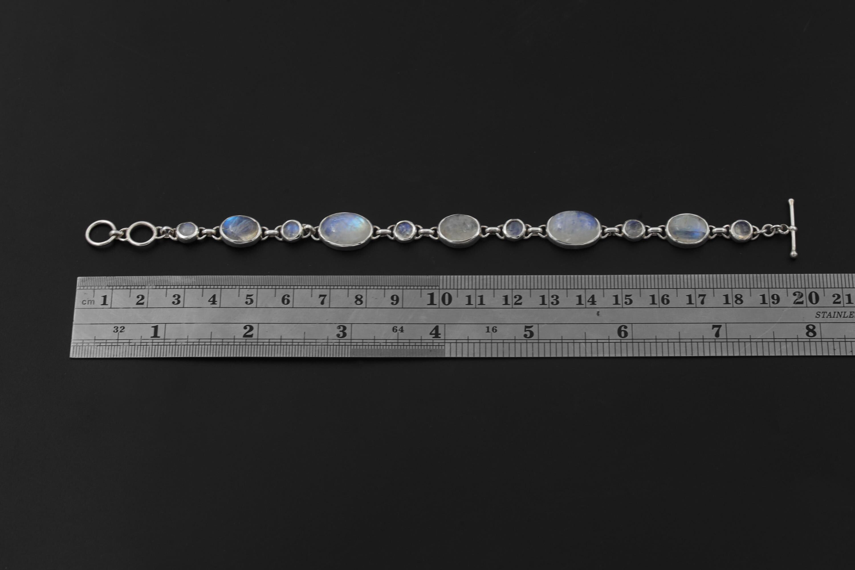 Rainbow Moonstone sterling silver bracelet shown beside a ruler for approximately 7.5 inch length reference.
