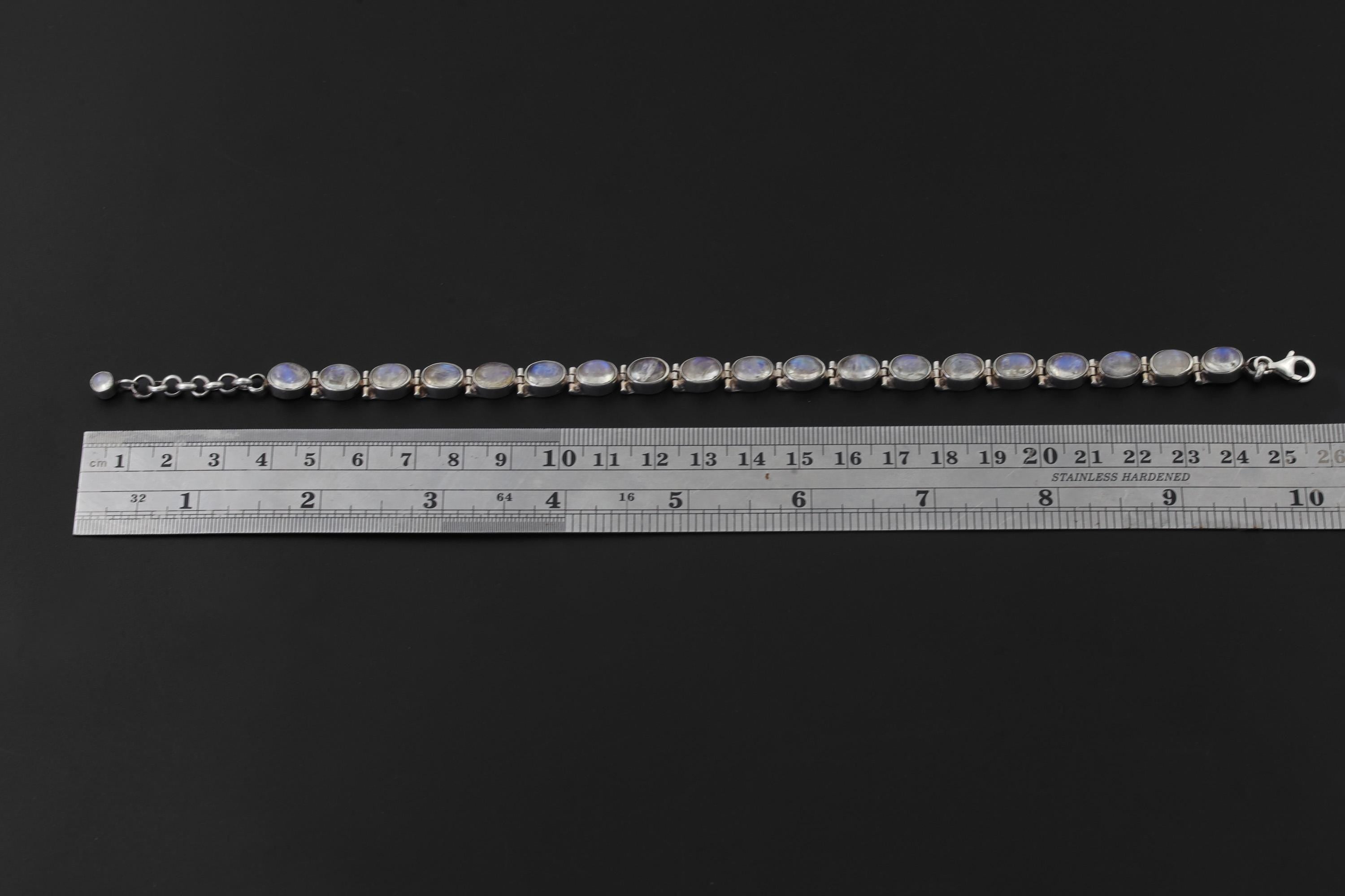 Blue Moonstone sterling silver bracelet shown beside a ruler for 21 cm plus 4 cm extension length reference.