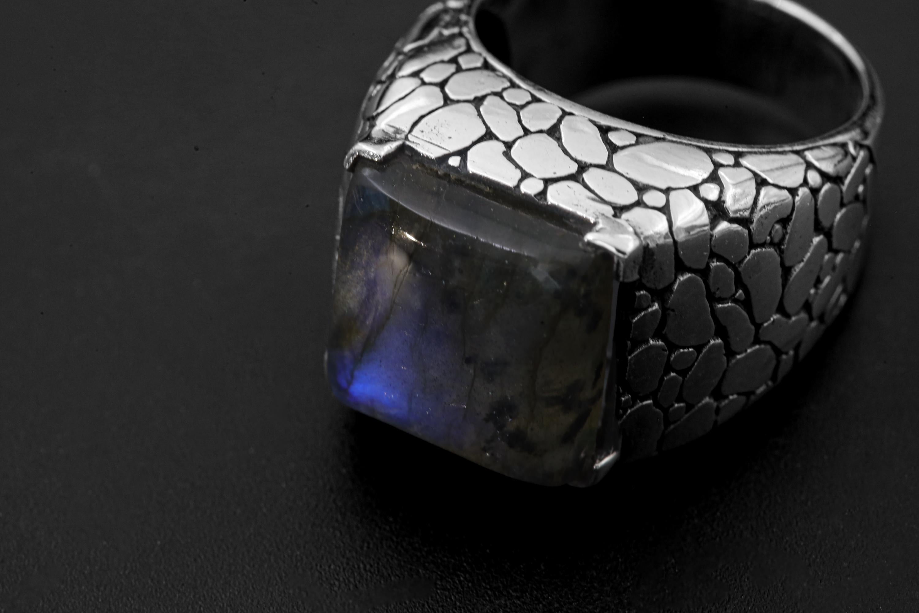 Close view of Labradorite ring showing square blue flash gemstone in raised sterling silver bezel.