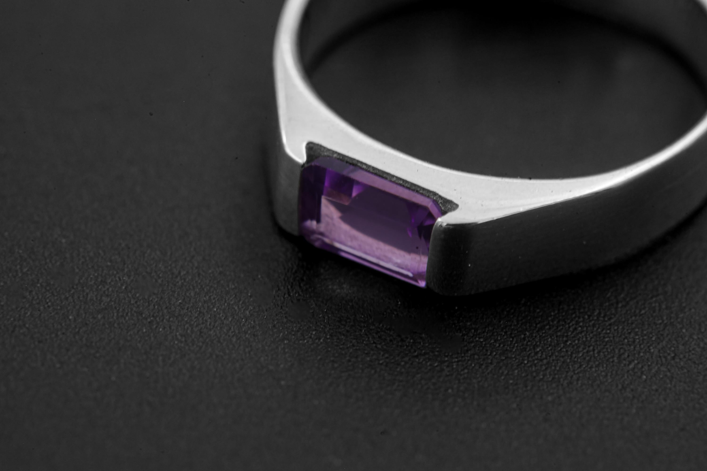 Close view of Amethyst sterling silver ring showing geometric stone seat and violet faceted gemstone.