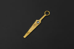 Gold-plated Blue Topaz cutter spoon pendant shown on black background with long serrated form.