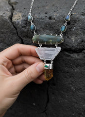 Harmony Labradorite Kunzite Apatite Emerald necklace shown held in hand, with raw Kunzite, Yellow Apatite, and Labradorite chain details.