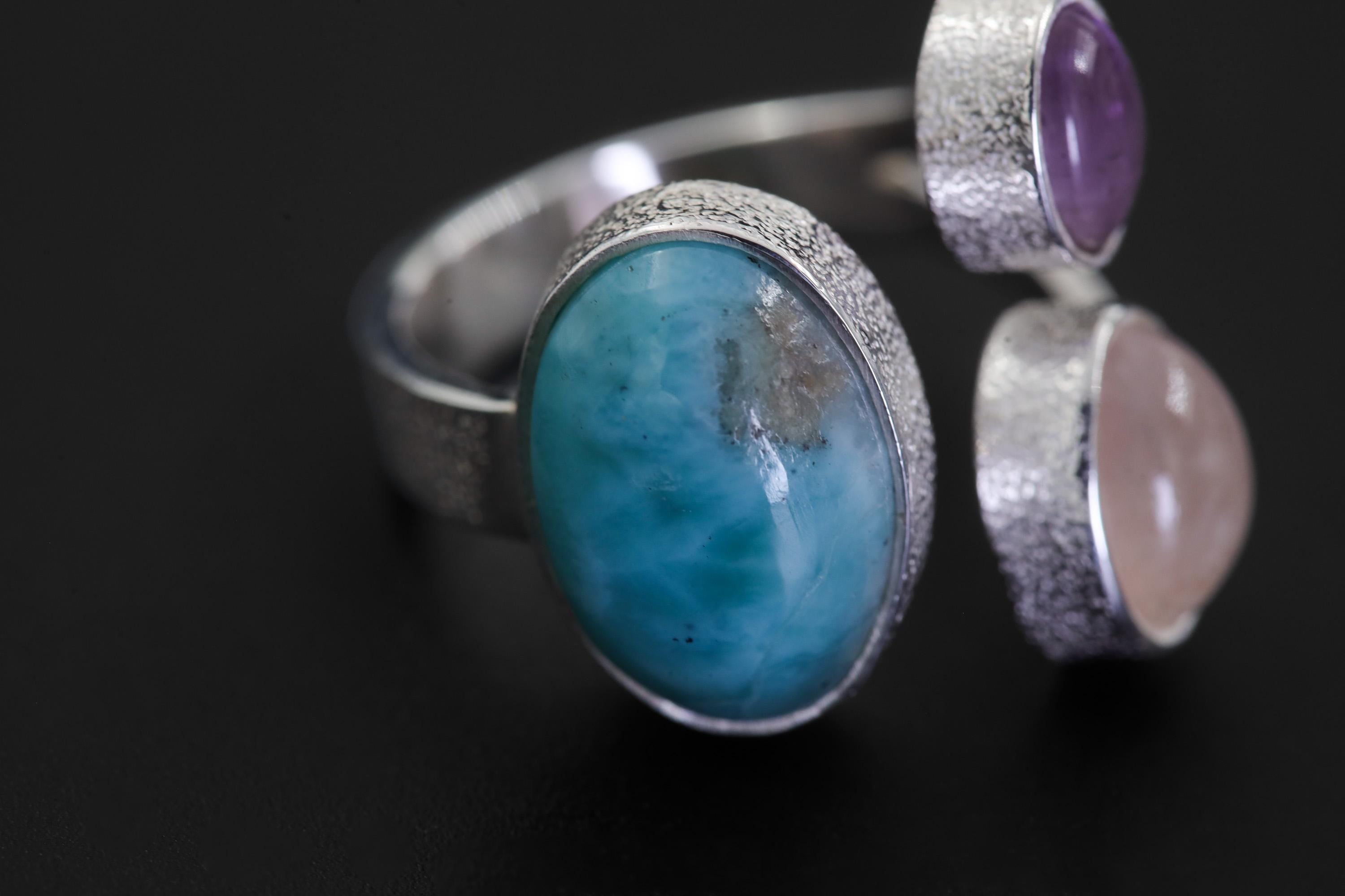 Close-up of Ocean Heart Multi Stone Ring showing Larimar cabochon, Amethyst, Rose Quartz, and textured silver details.