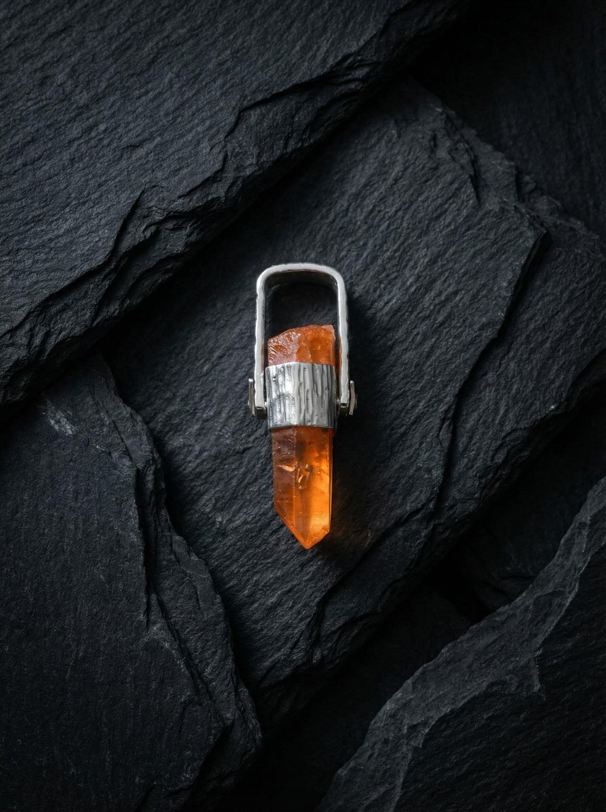 Australian Lemurian Quartz pendant shown worn on a model, with warm orange crystal point and hammered sterling silver cap.